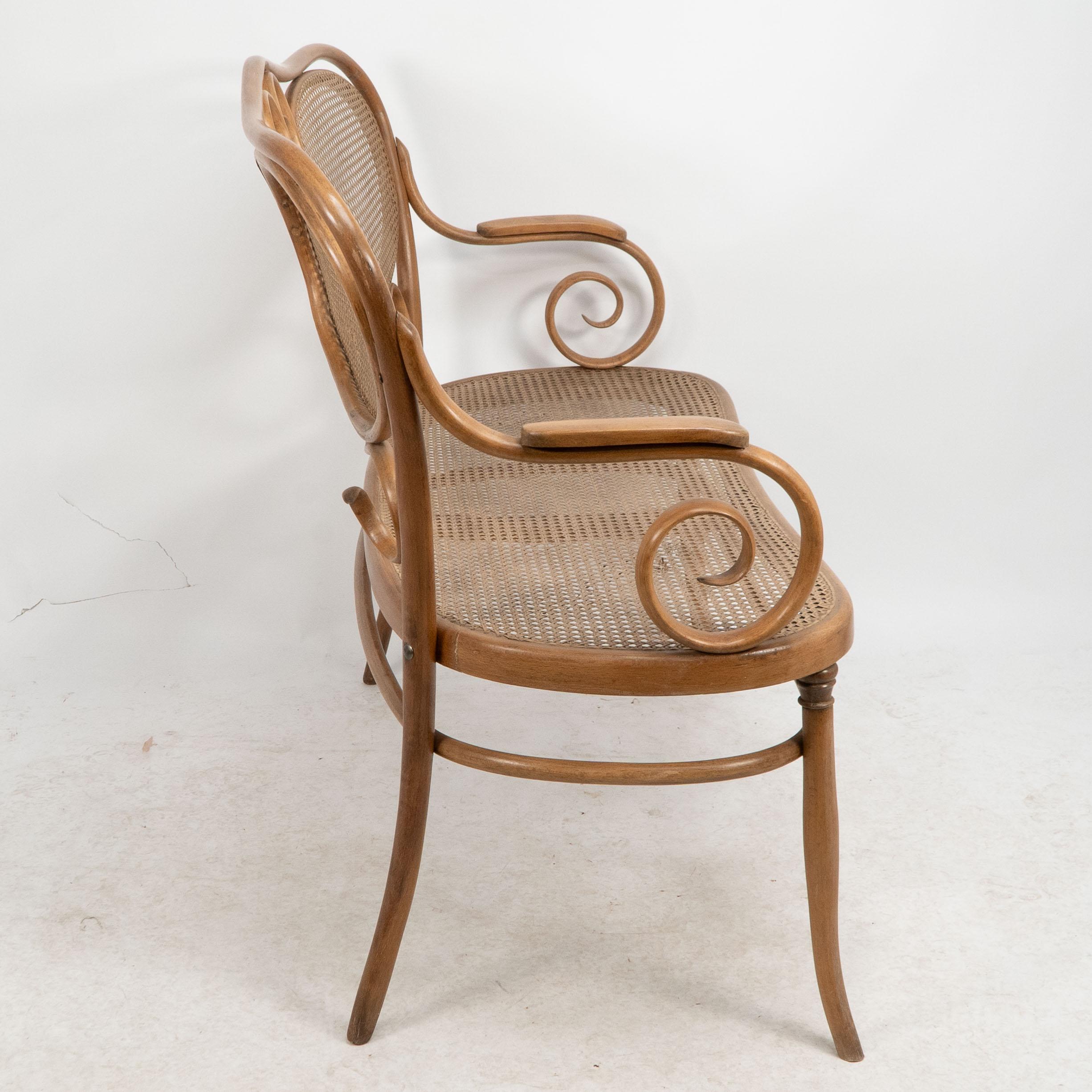 Hand-Crafted Thonet. A bentwood settee with scrollwork decoration with caned seat & back For Sale