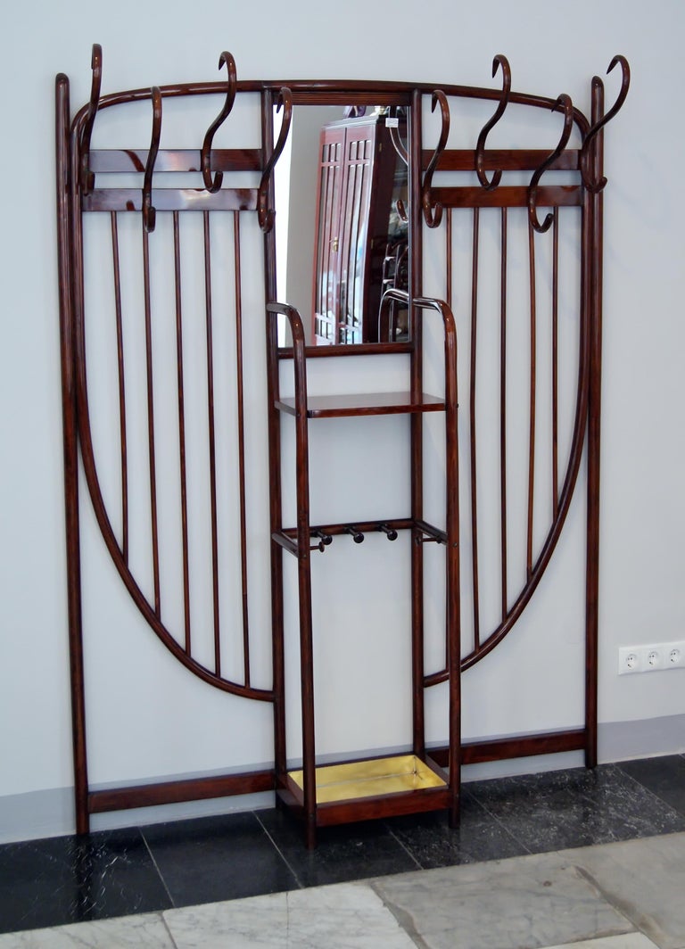 Art Nouveau most elegant Thonet wall-mounted coat rack:
Finest quality of bentwood manufacturing (mahogany stained). 

beech wood / handwork of finest quality / refurbished by hand
there are eight hooks existing for hanging up coats and hats / a