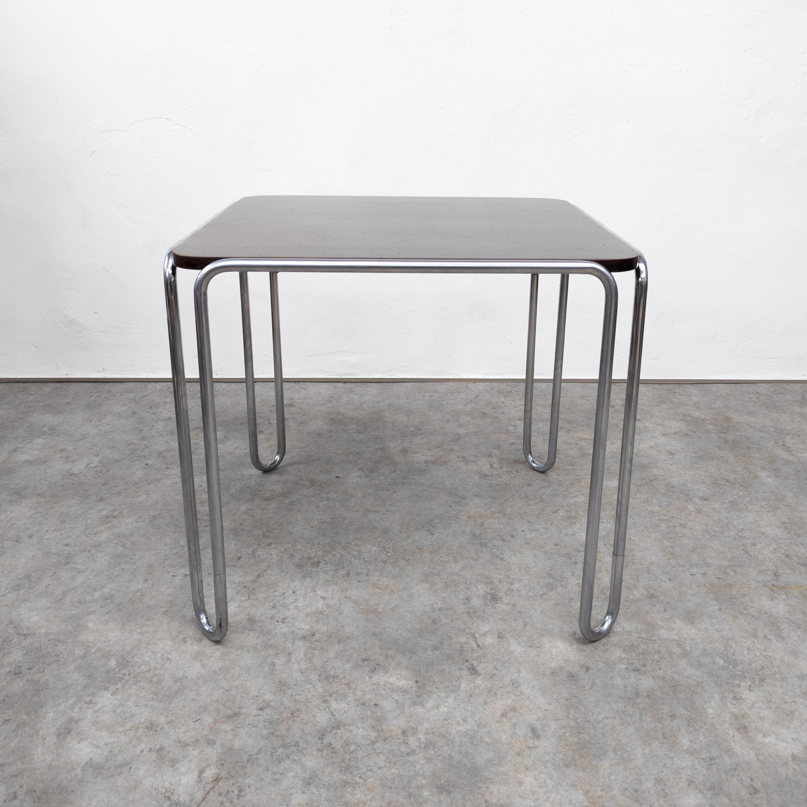 The Thonet B10 table designed by Marcel Breuer is an iconic piece of modernist furniture. It features a sleek, tubular steel frame with a  wooden top, embodying the Bauhaus principles of simplicity, functionality, and geometric forms. The design is