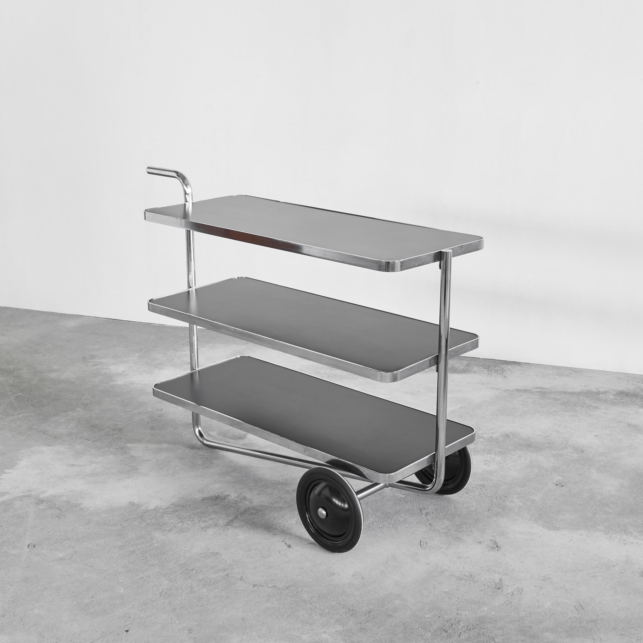 Thonet Bauhaus Style Tubular Trolley or Bar Cart 1980s.

Wonderful and rare Bauhaus style trolley or bar cart in the style of Thonet. Very well designed with a timeless and modern appearance due to the combination of black laminate and the chromed