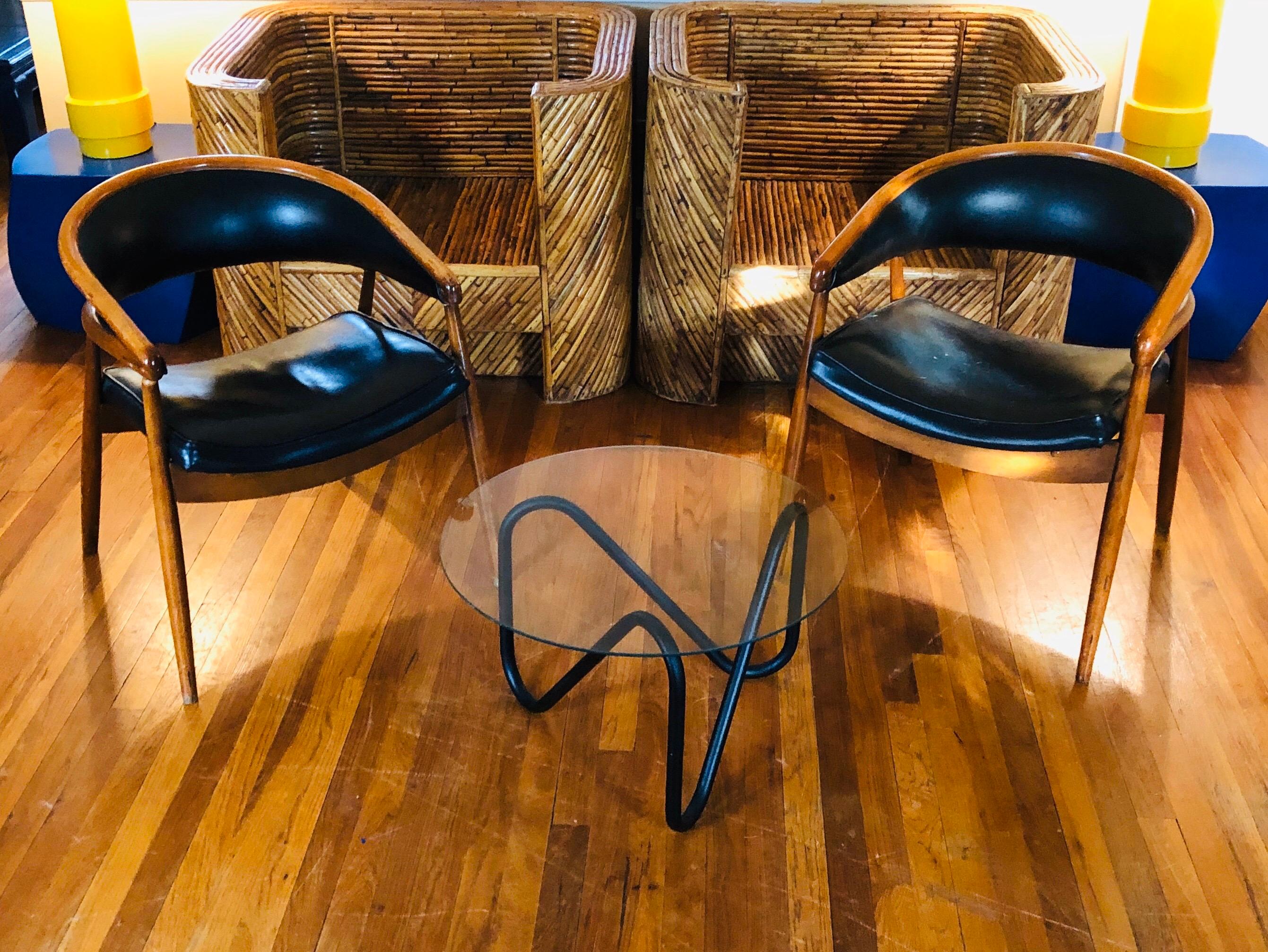 These curvaceous midcentury chairs have graceful legs and curves in all of the right places. They look equally beautiful from their front, sides and back. Famously chosen by James Mont for his work on the King Cole penthouse, circa 1955. Comprised