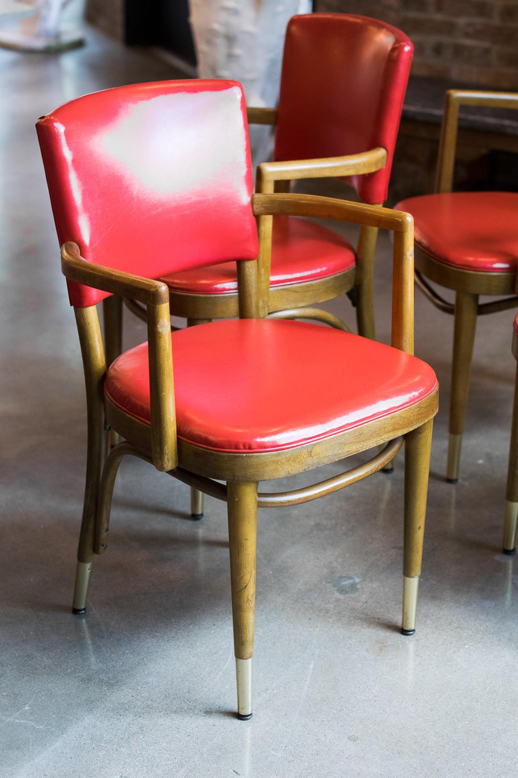 Set of six Thonet bentwood armchairs with manufacturer's label underneath seat. Beech frames with brass capped feet and upholstered backs and seats, 1950s. Measures: Seat height 18 inches.