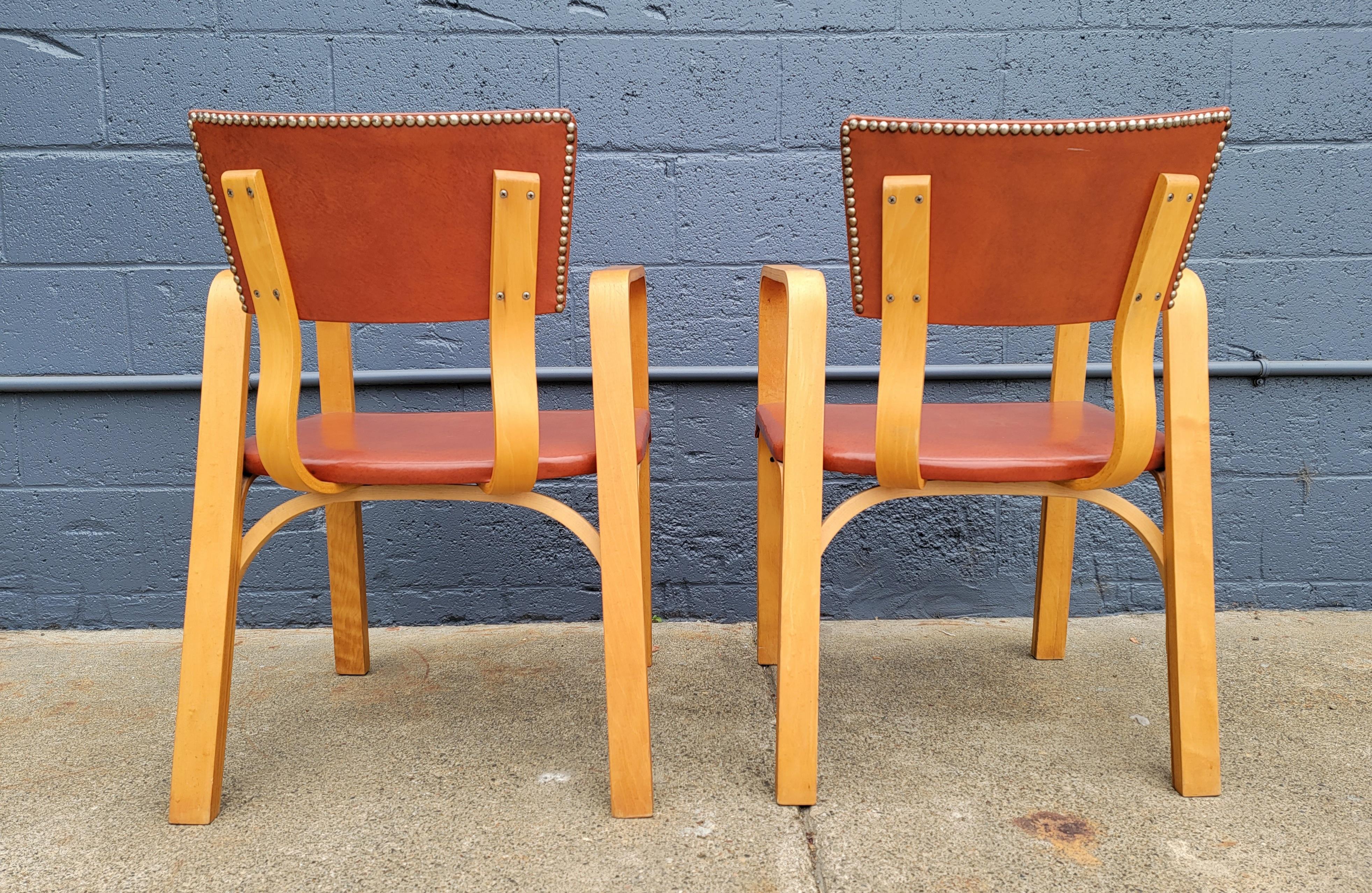 A pristine pair of steamed, bentwood side chairs by Thonet. Beautiful, architectural design. Fine craftsmanship. Structurally very sturdy. Thumb tack detail to back side of chairs. Retailing original upholstery. 