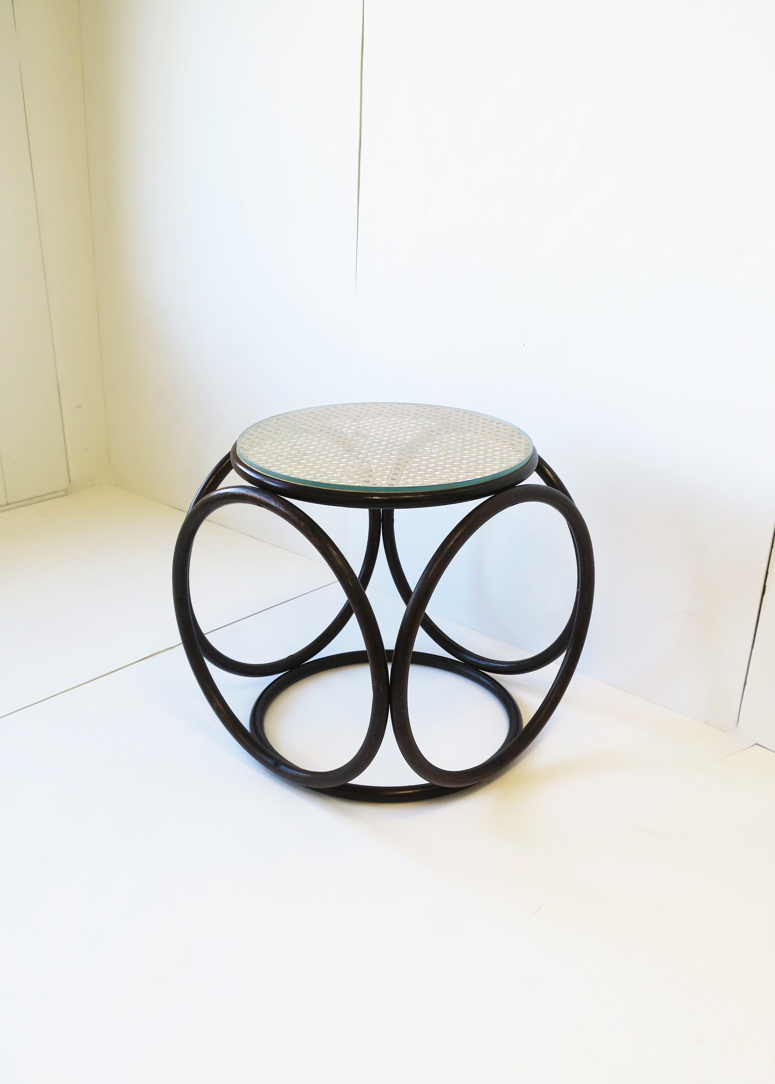 A beautiful modern bentwood, wicker cane and glass top side drinks table or stool, circa Mid-20th Century, Europe, possibly Austria. This table or stool has a beautiful rich dark bentwood, blonde cane top, and custom glass top to protect and