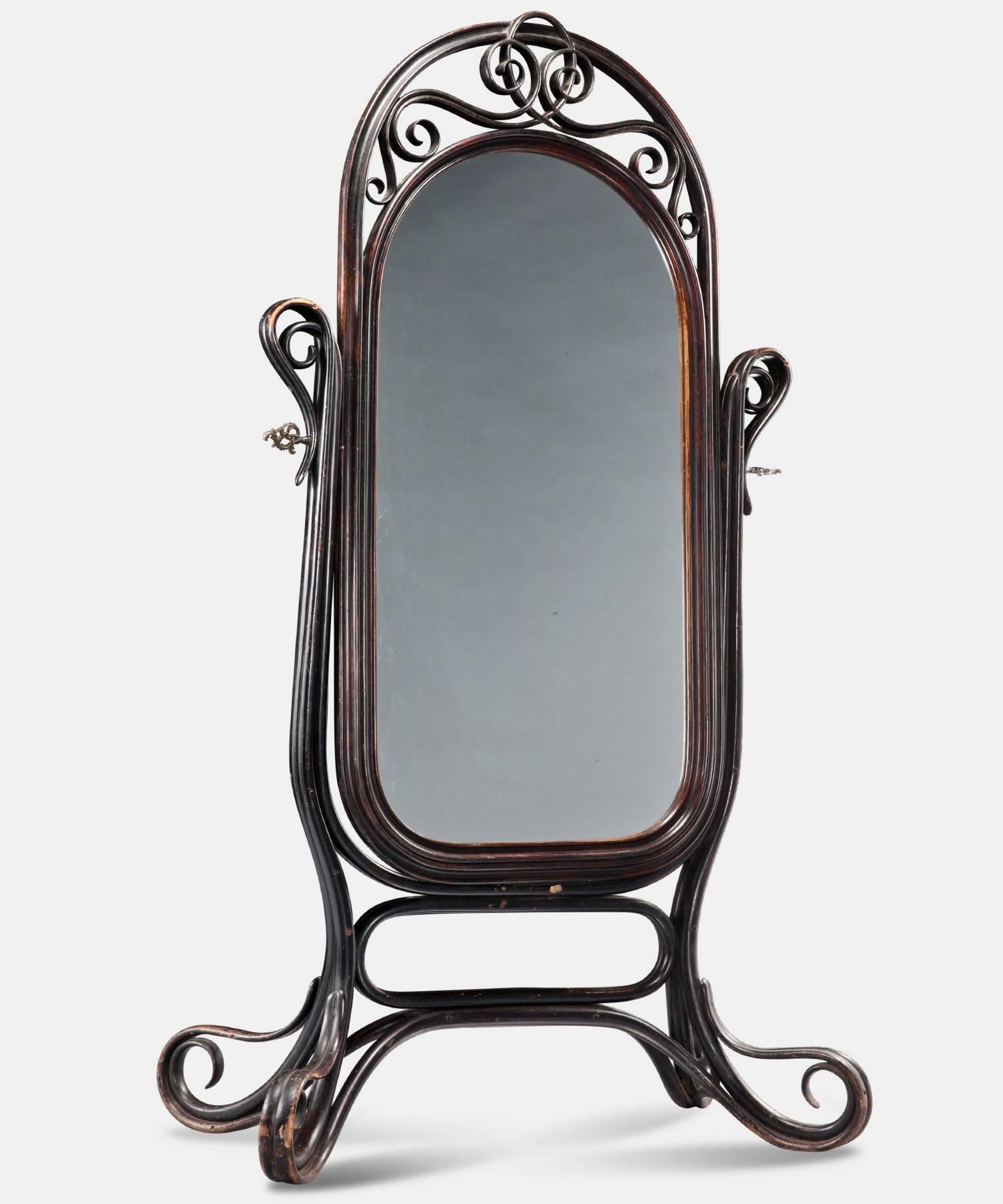 Floor mirror with bentwood frame and beveled glass.