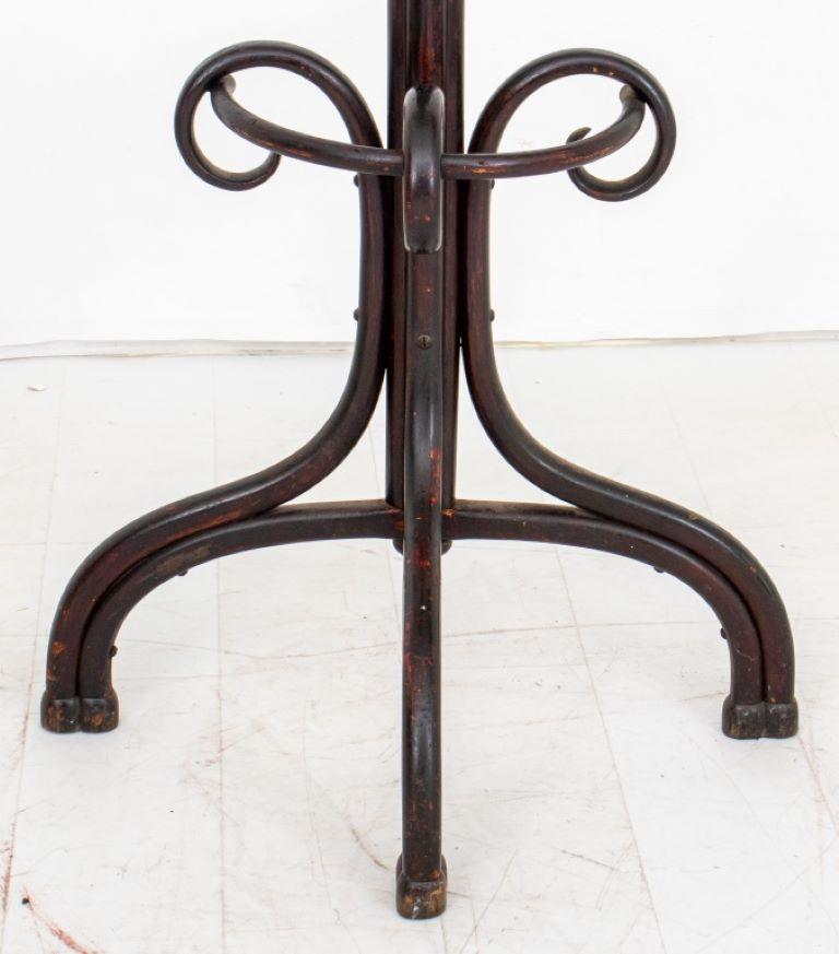 Thonet bentwood hall coat rack, with finial top, four double hooks for coats, and three bentwood scrolls at base anchoring an umbrella and cane rack.

Dealer: S138XX
