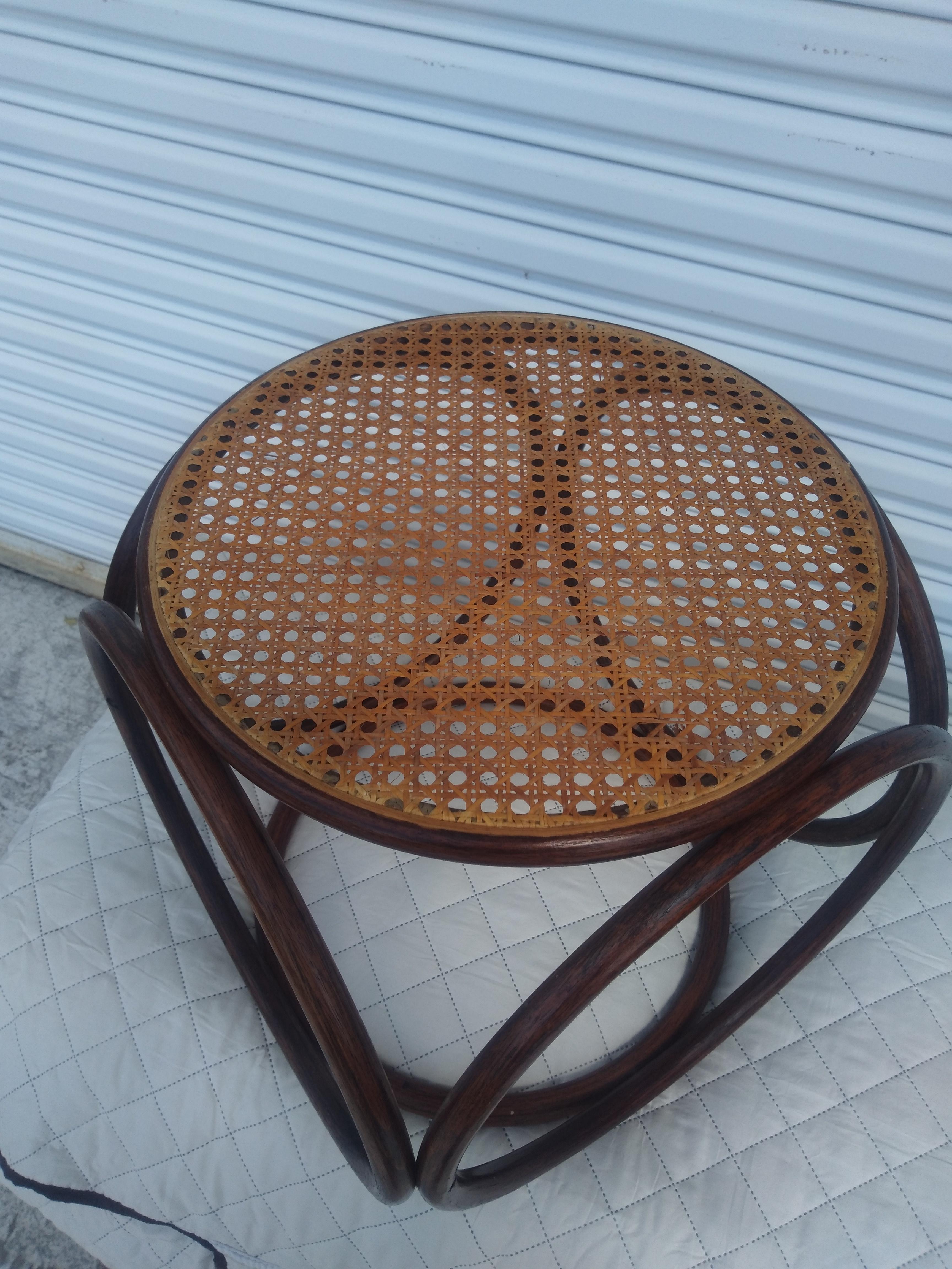 This is a beautiful Thonet Bentwood stool. The seat is made of cane. The rings are bentwood.

A nice addition to a boho chic decor.