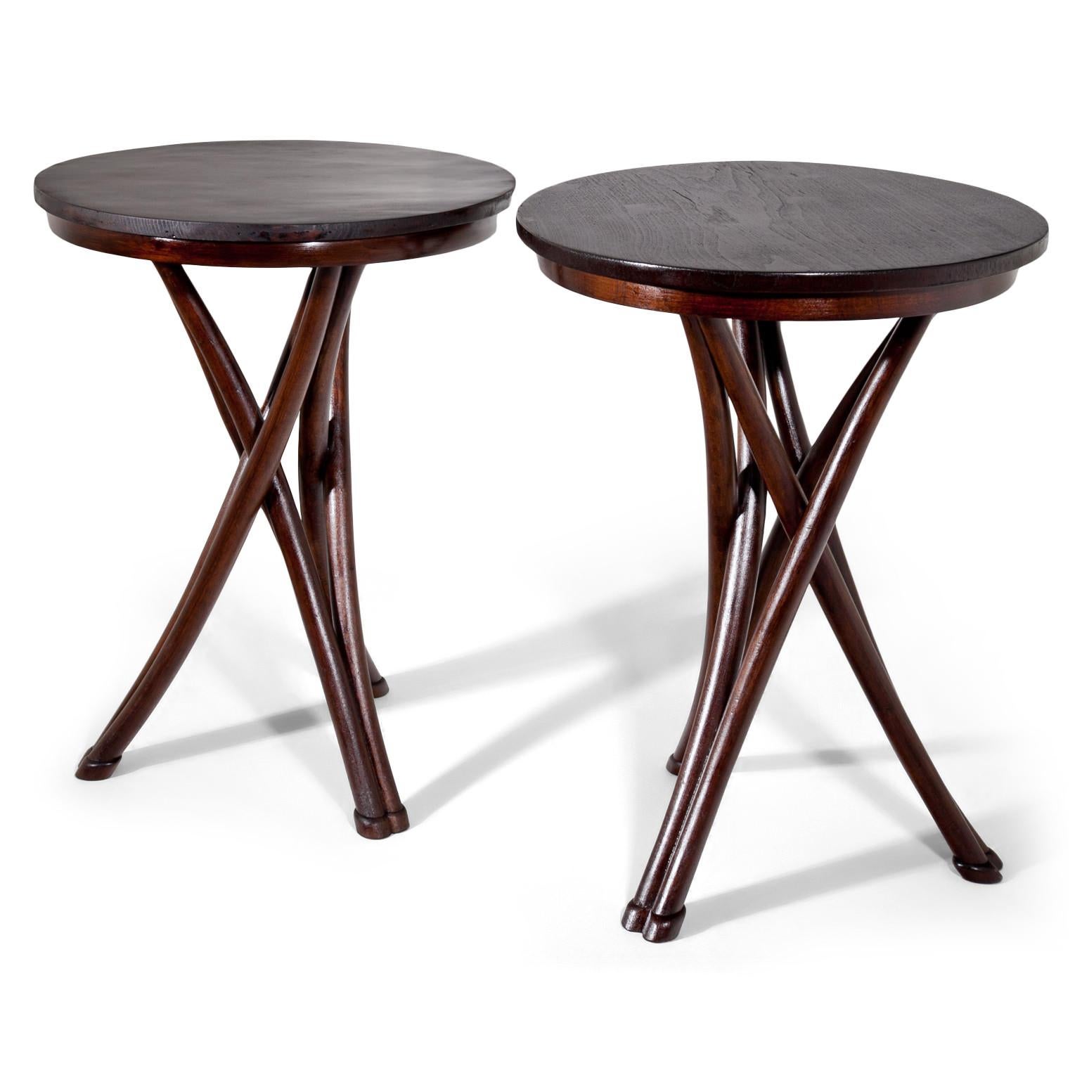Two game tables No. 13 with slightly different heights (77 and 75.5 cm) and round table tops as well as crossed legs out of bentwood. These are a near pair and the table tops are restored. Both are stamped THONET. Lit: Peter W. Ellenberg: Gebrüder
