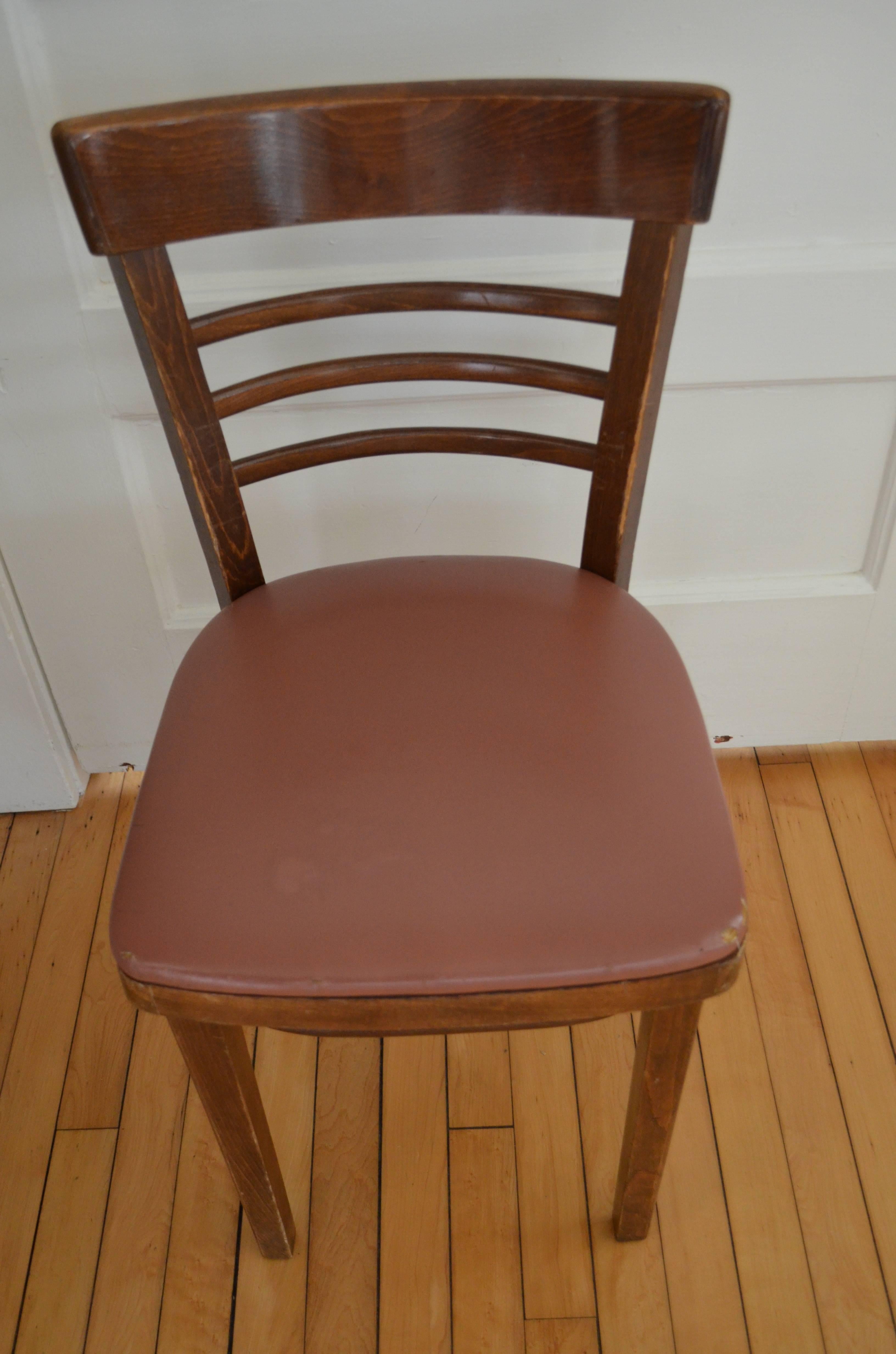 Thonet midcentury cafe and restaurant chairs. Priced as a set of eight. Total of 22 are available. Small footprint with sturdy, wooden ladder frame. Seats are currently upholstered in naugahyde but can be easily and inexpensively reupholstered as