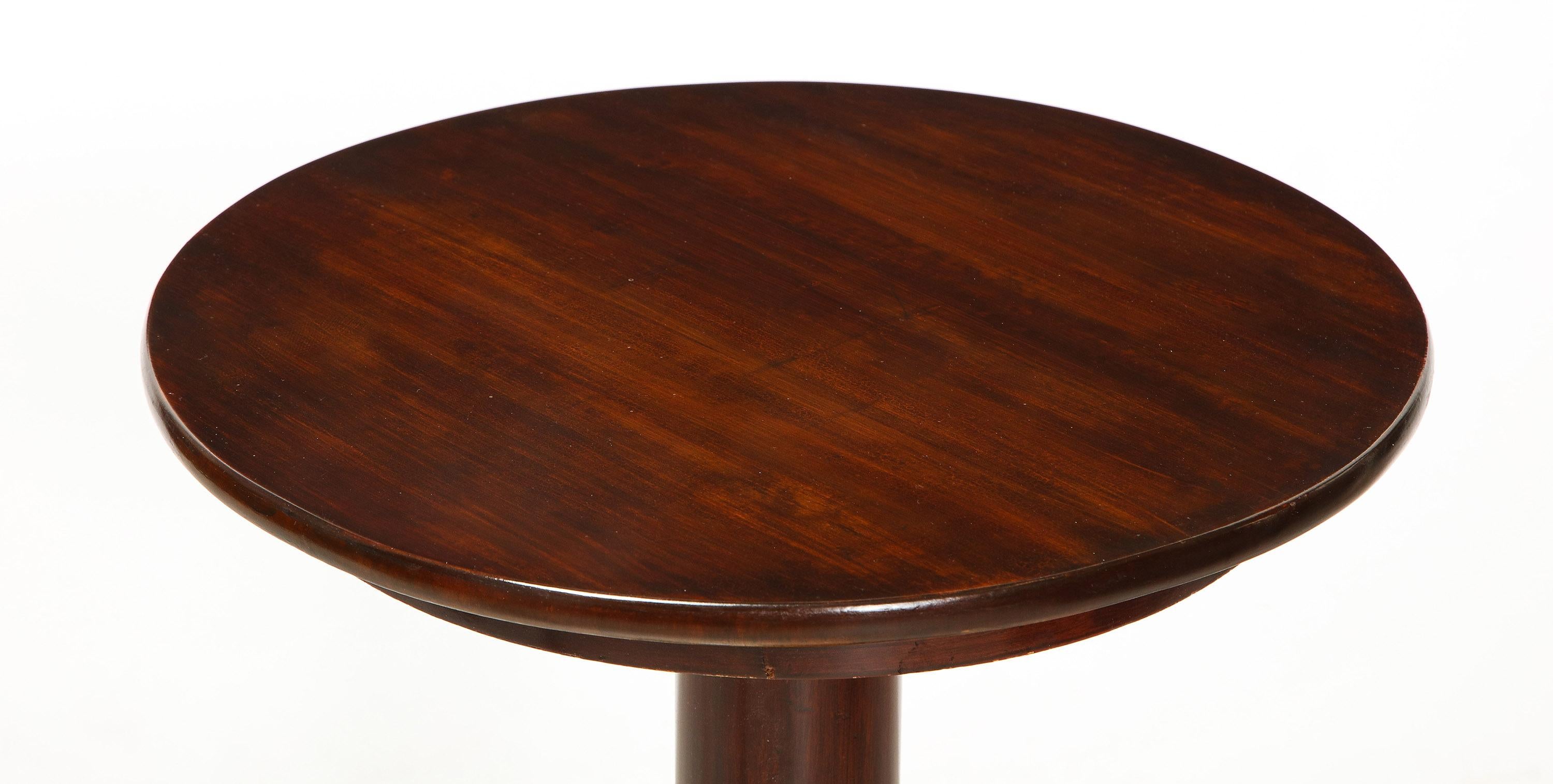 Thonet center table with brass and leather base

Of beechwood construction finished in a mahogany color, the circular top on a brass banded column supported by a leather and brass base. 

Original Thonet table under the top.