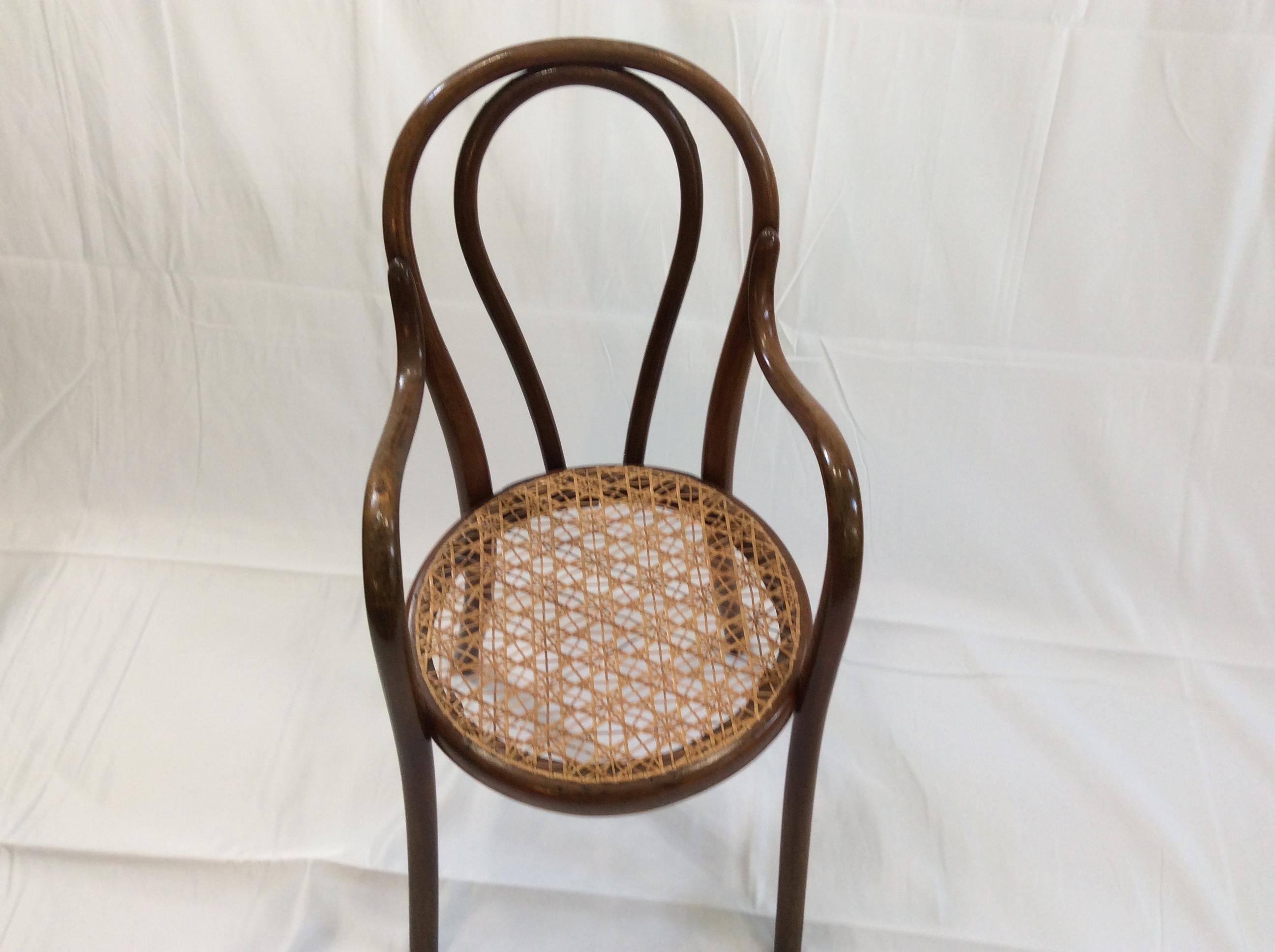 Wonderful Thonet children’s chair, bentwood design perfected by the Thonet family.
The chair has hand caned seat in a star and diamond pattern, most likely replaced in the 20th century. 
Paper label Thonet and Wein and also branded with Thonet