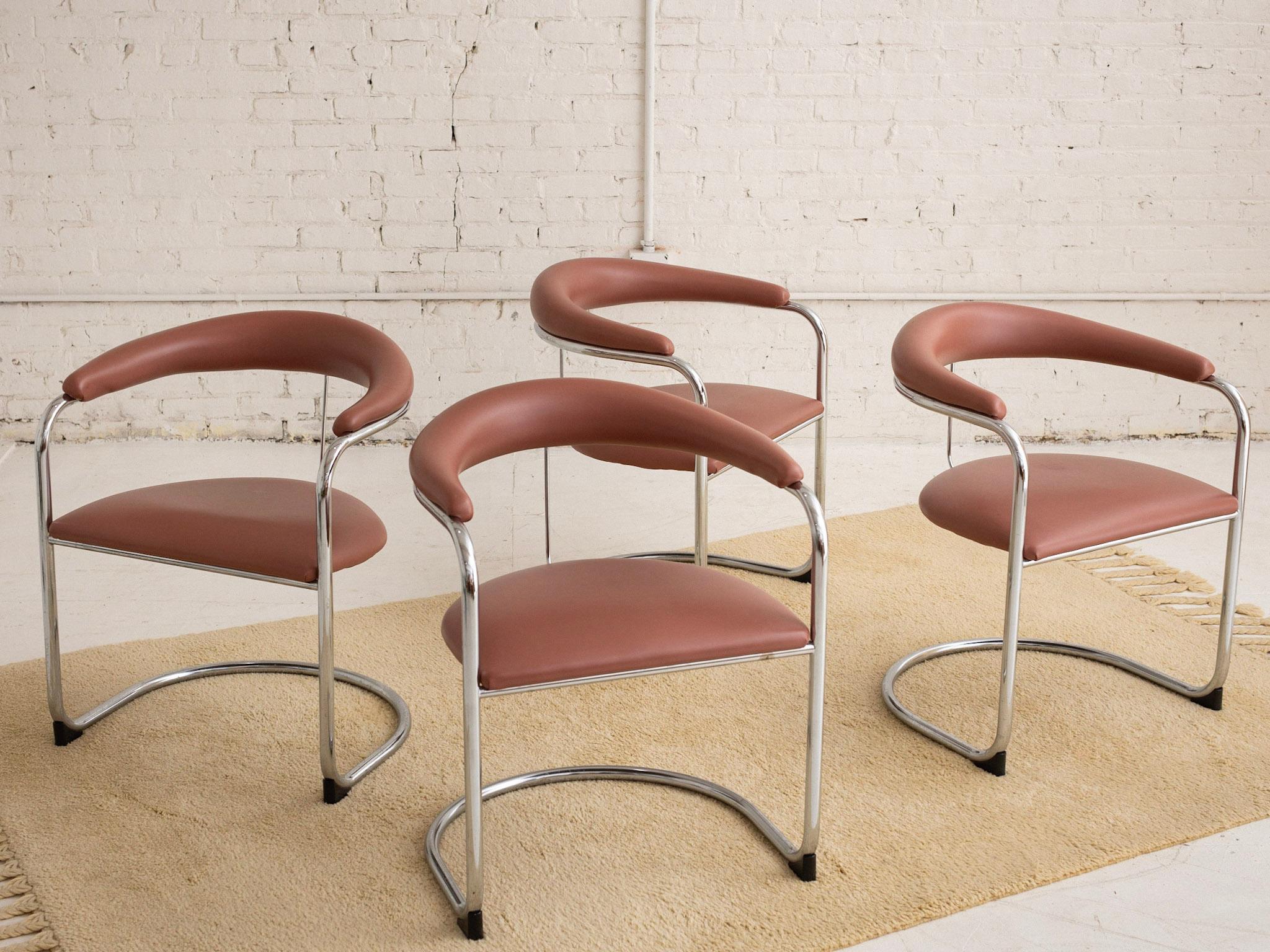 A set of 4 armchairs designed by Anton Lorenz and produced by Thonet. Tubular steal frames with pink vinyl seats and back rests. Retains original manufacturer tags.