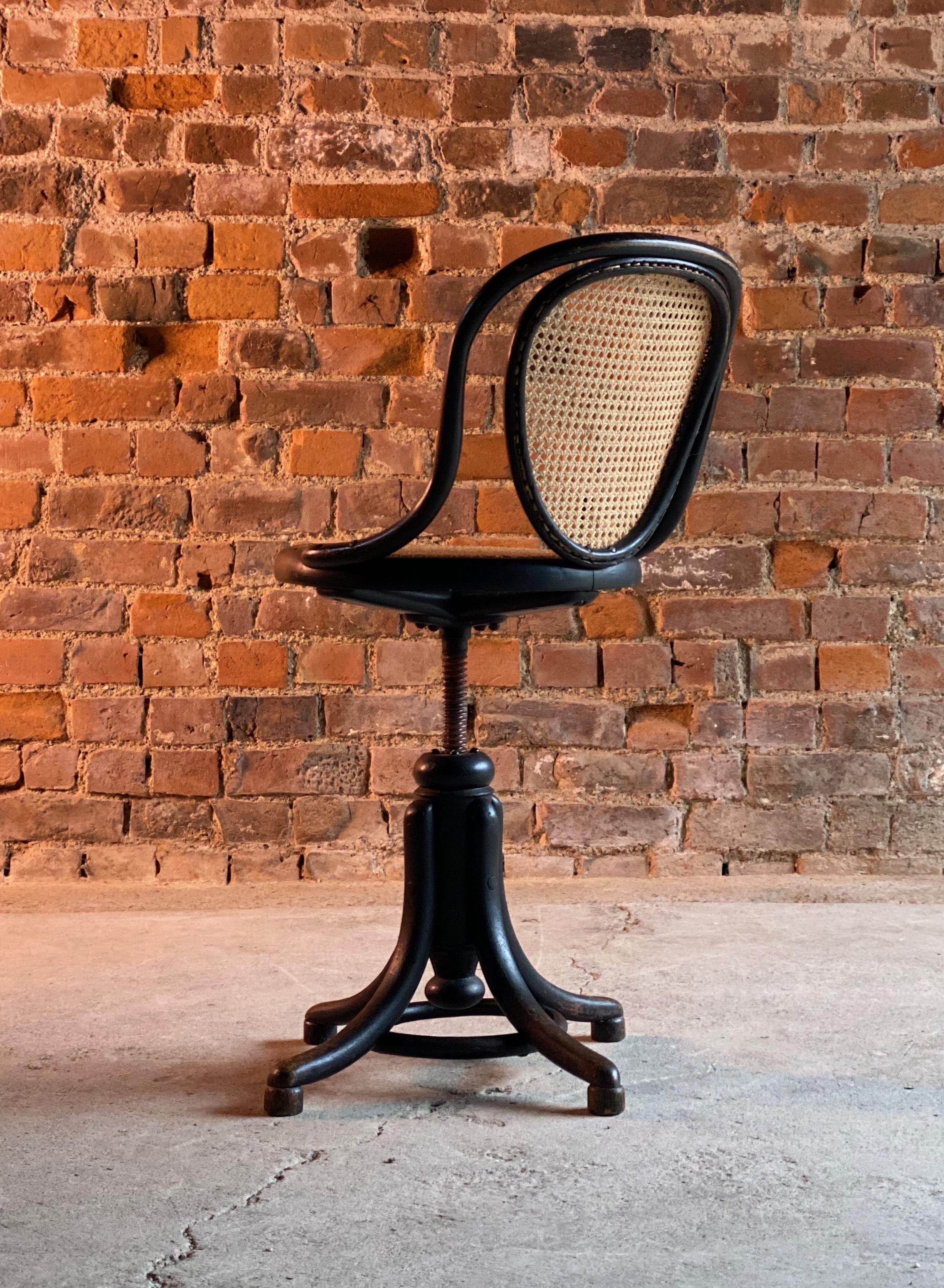 Thonet ebonized bentwood swivel office chair Austria circa 1900

cagnificent rare Thonet ebonized bentwood swivel office desk chair dating to early 20th century circa 1900, with cane back and circular seat, adjusting on a metal thread to four
