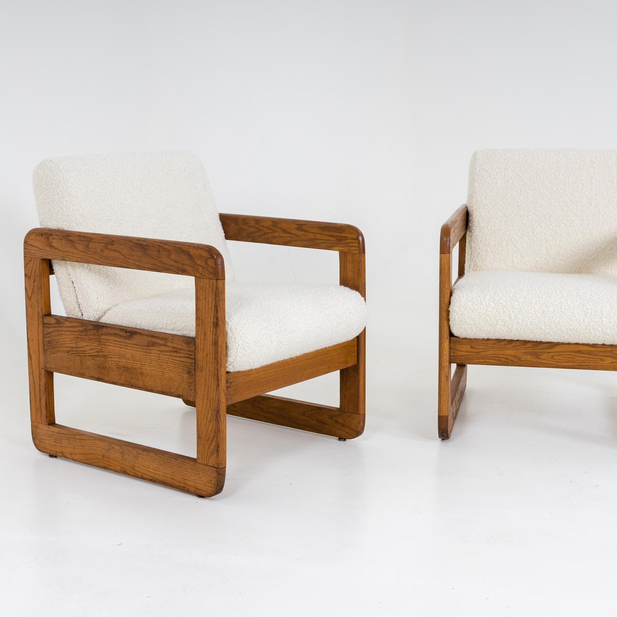 Pair of Thonet lounge chairs with frames in oak and seat cushions with white bouclé cover. Label on the bottom.