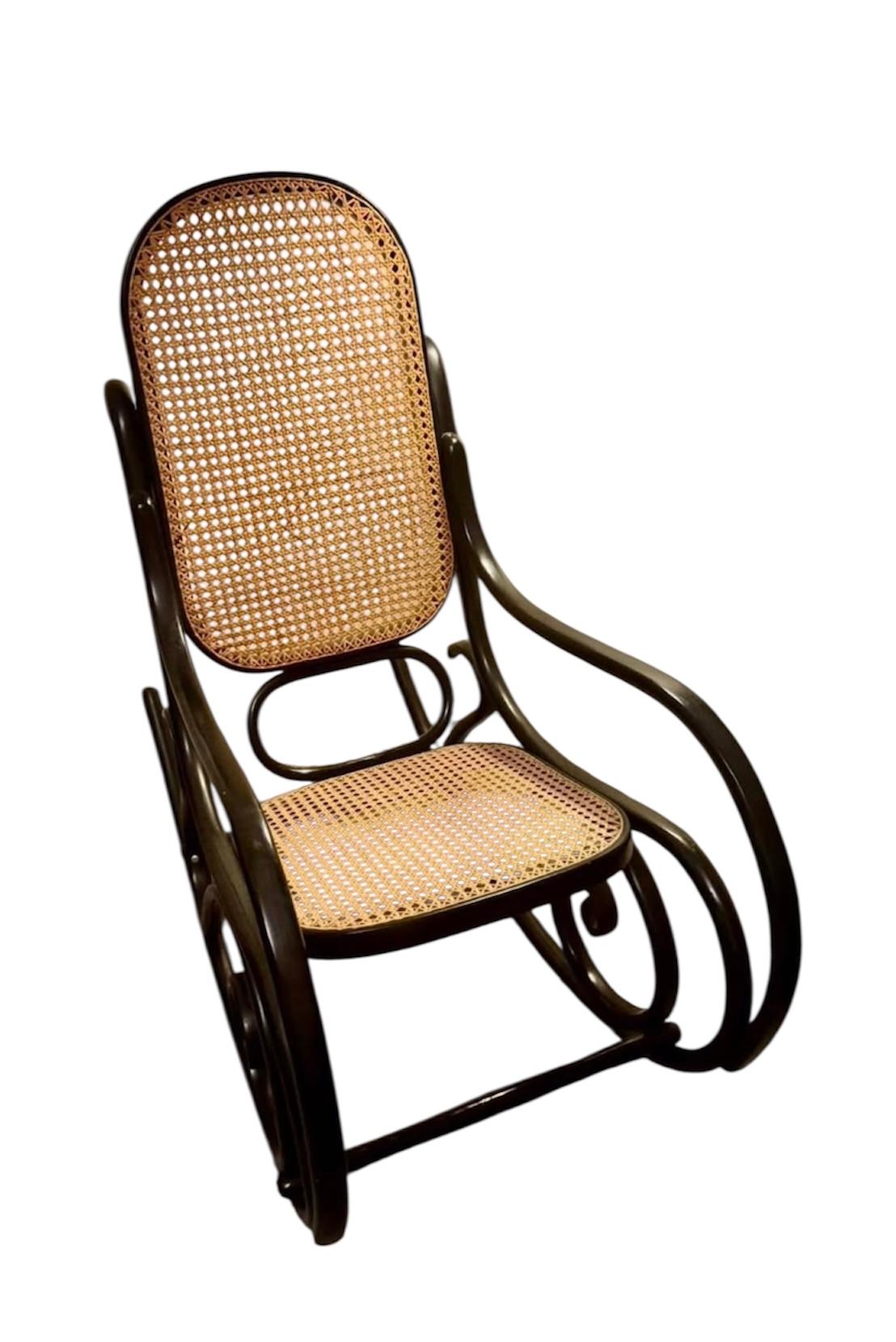 This is a classic Thonet Model No. 10 bentwood rocking chair, a timeless example of 19th-century European design that merges elegance with comfort.
	•	Bentwood Frame: Crafted from steam-bent beechwood, the frame displays Thonet’s signature curves