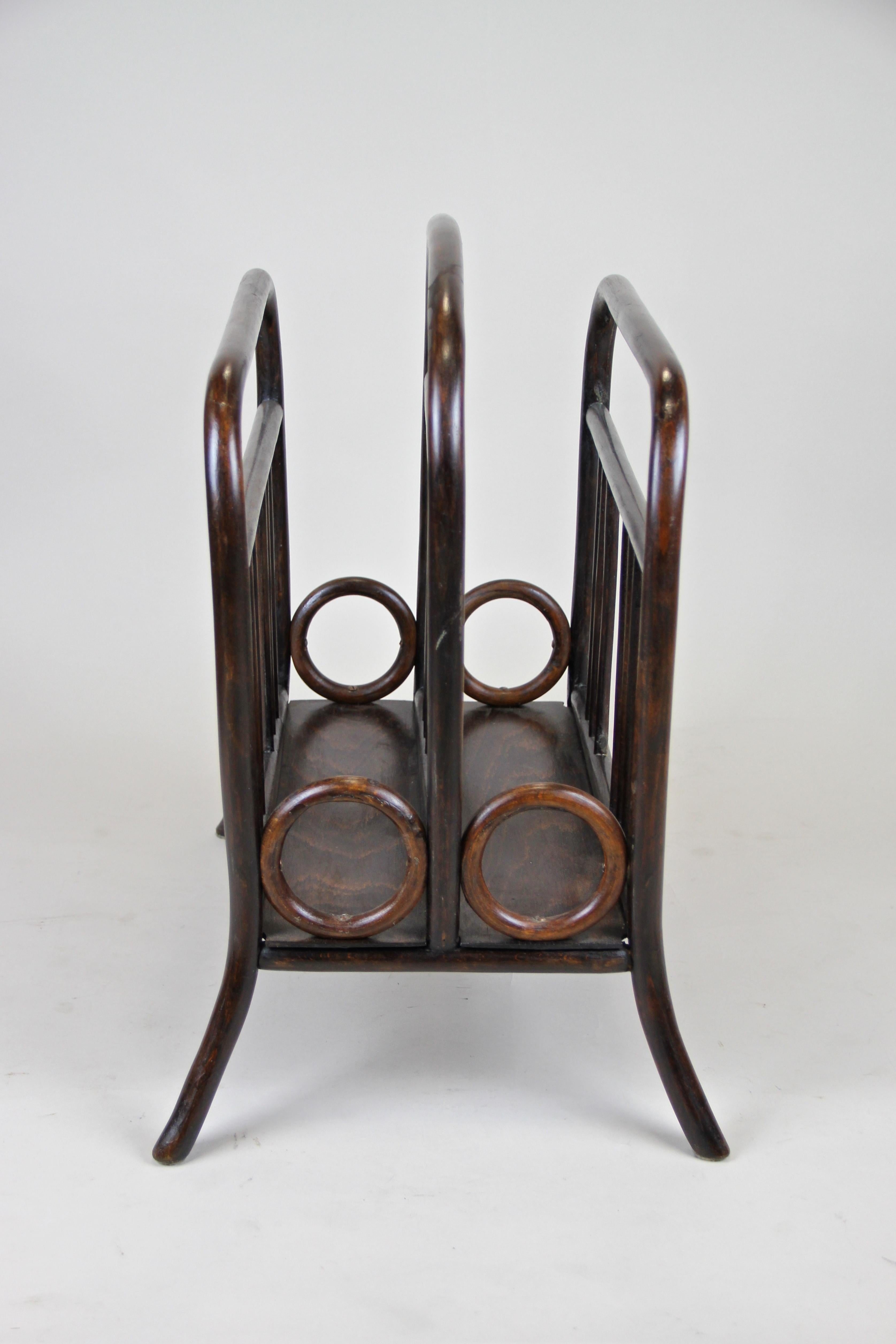 Elegant Thonet Newspaper Rack, catalogue No. 33, from Austria circa 1905. Made of Fine bentwood and trimmed to a beautiful nut wood look, this rack comes with two compartments for your magazines and could be also used for storing vinyls. Marked with