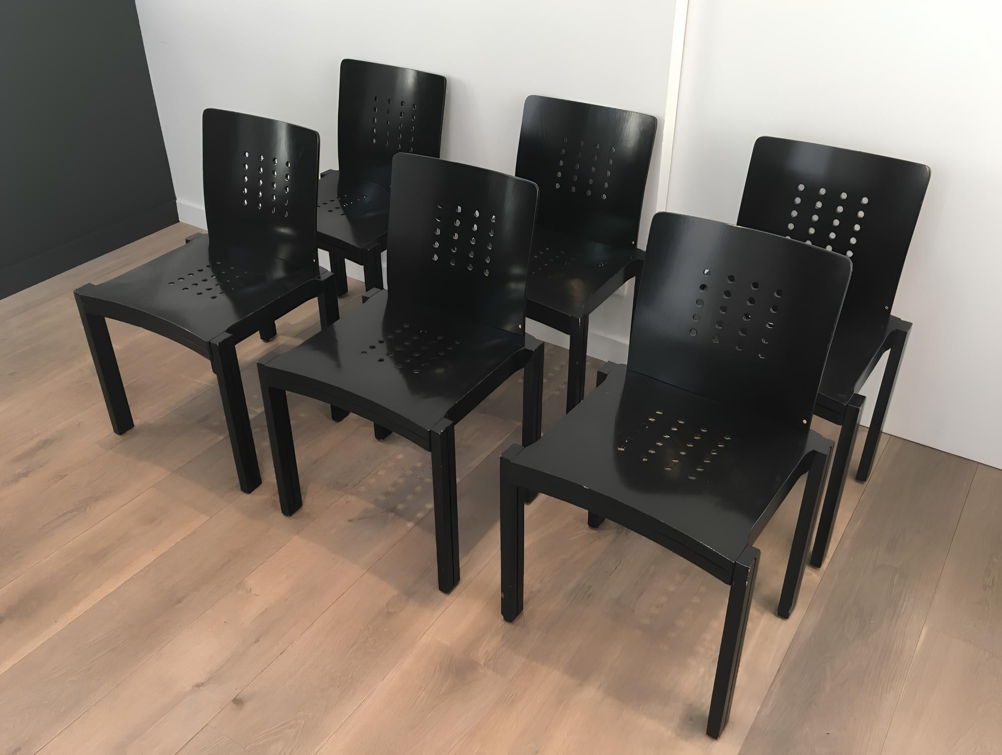 This set of 6 design black wood chairs is stamped Thonet-Vienna-1993 and has the gold Thonet incrusted label. 
They have a nice design, are large and very comfortable with their carved back. They Vienna-Austria, 1993.
In fact, we have 20 of these