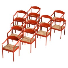 Juego de doce sillones Thonet con estructura lacada en rojo y asientos de junco
