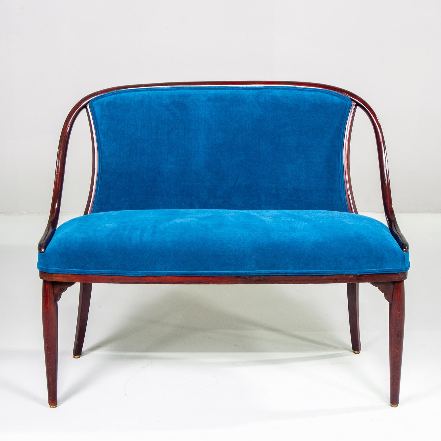 Thonet upholstered settee with dark wood frame and newly upholstered in teal blue colored velvet. Measures: Arms are 22.25” high and seat is 19.25” high and 20.25” deep, circa 1930s.



 