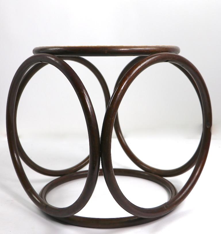 Circular stool, side or end table by Thonet. This table has a circular wood structure, with a caned top surface. Good original condition, clean and ready to use.