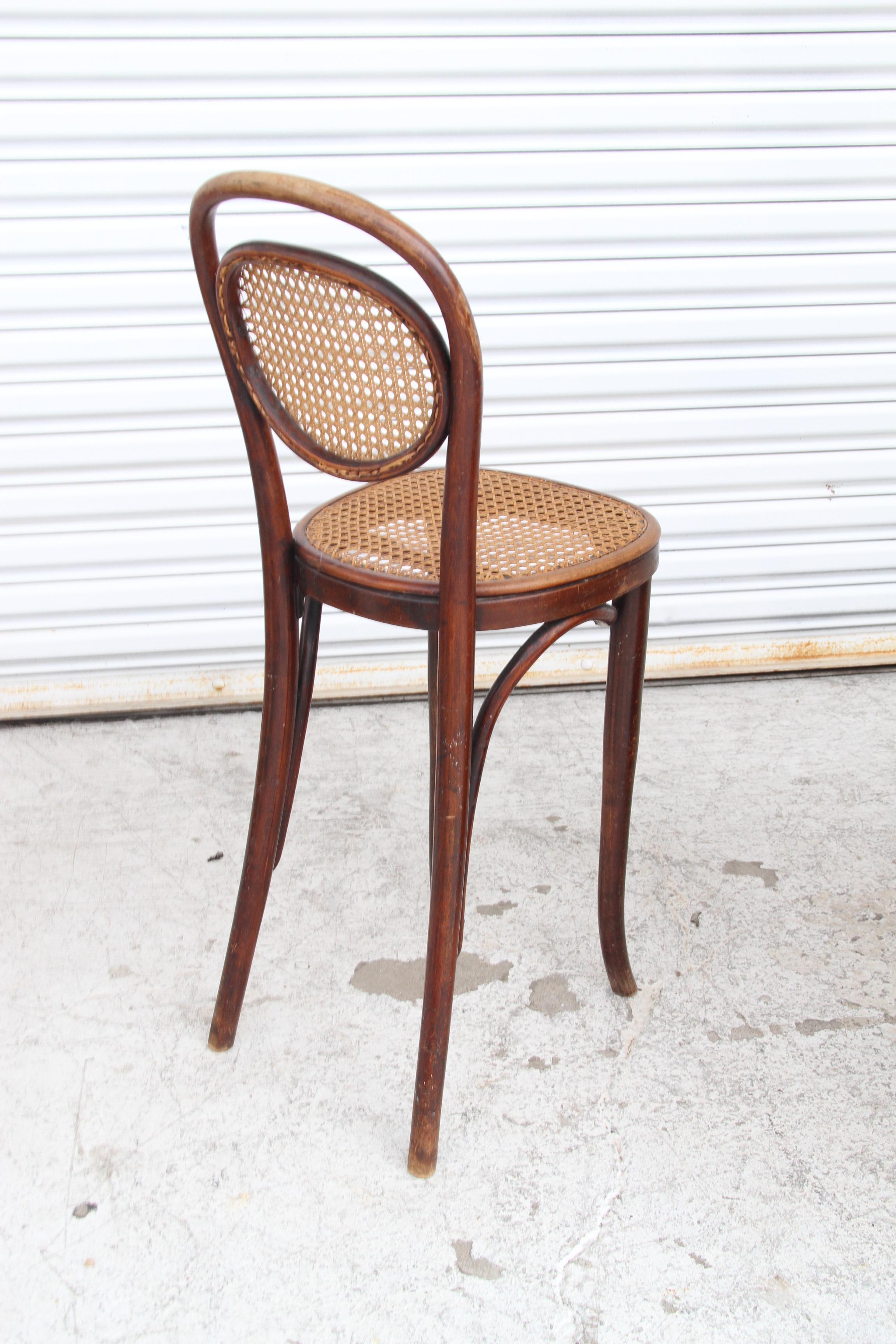 This is a bentwood counter stool made in the manner of Thonet. It's has a cane back and seat. It's constructed nice and would make a nice addition to any counter area.