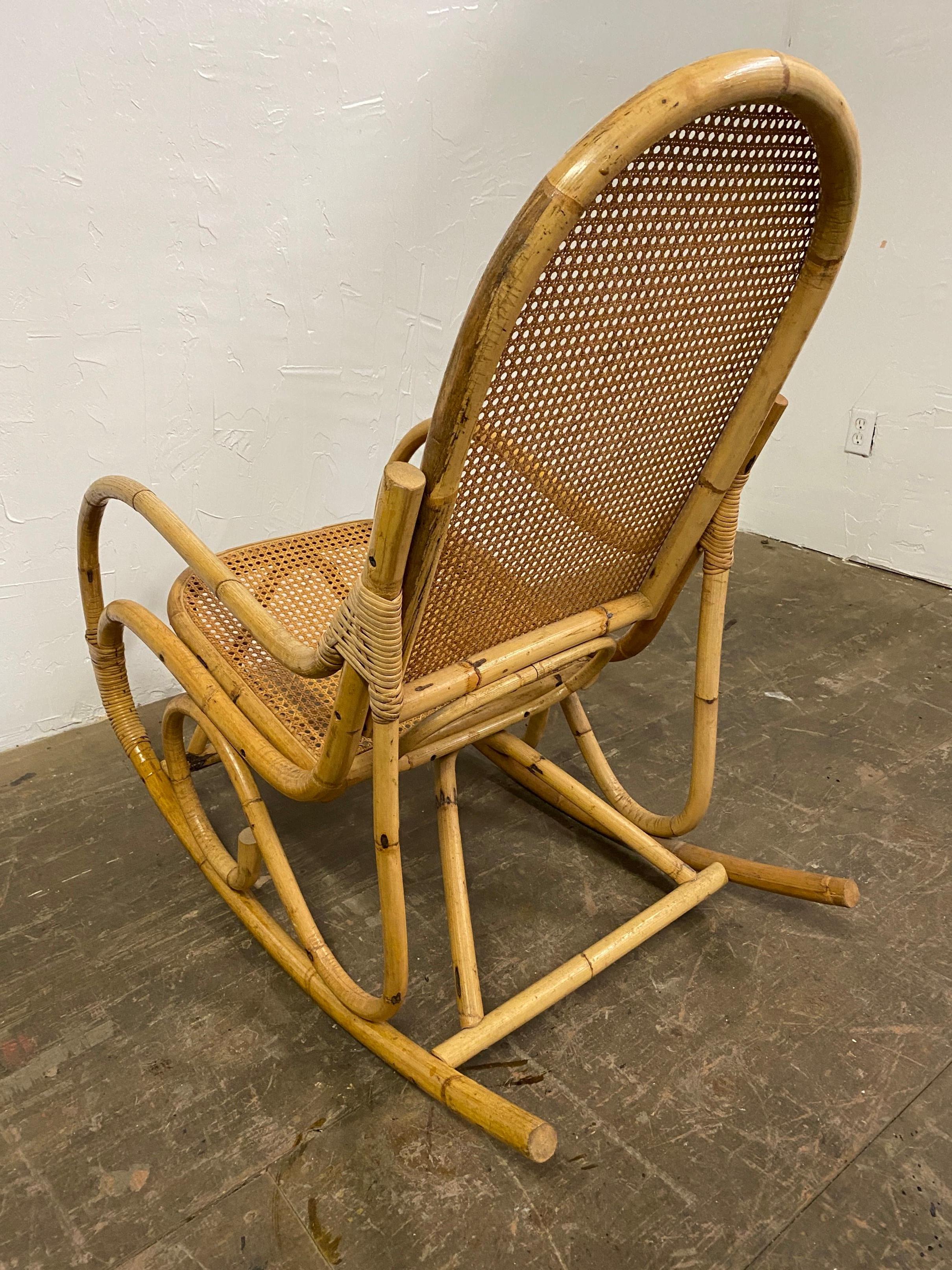 Great Art Deco Thonet style faux bamboo bentwood rocking chair with caned seat and back. A design classic that should not be missing in any home! Wonderful chair to add to any room for comfortable and relaxing seating.
Arm h = 23.5