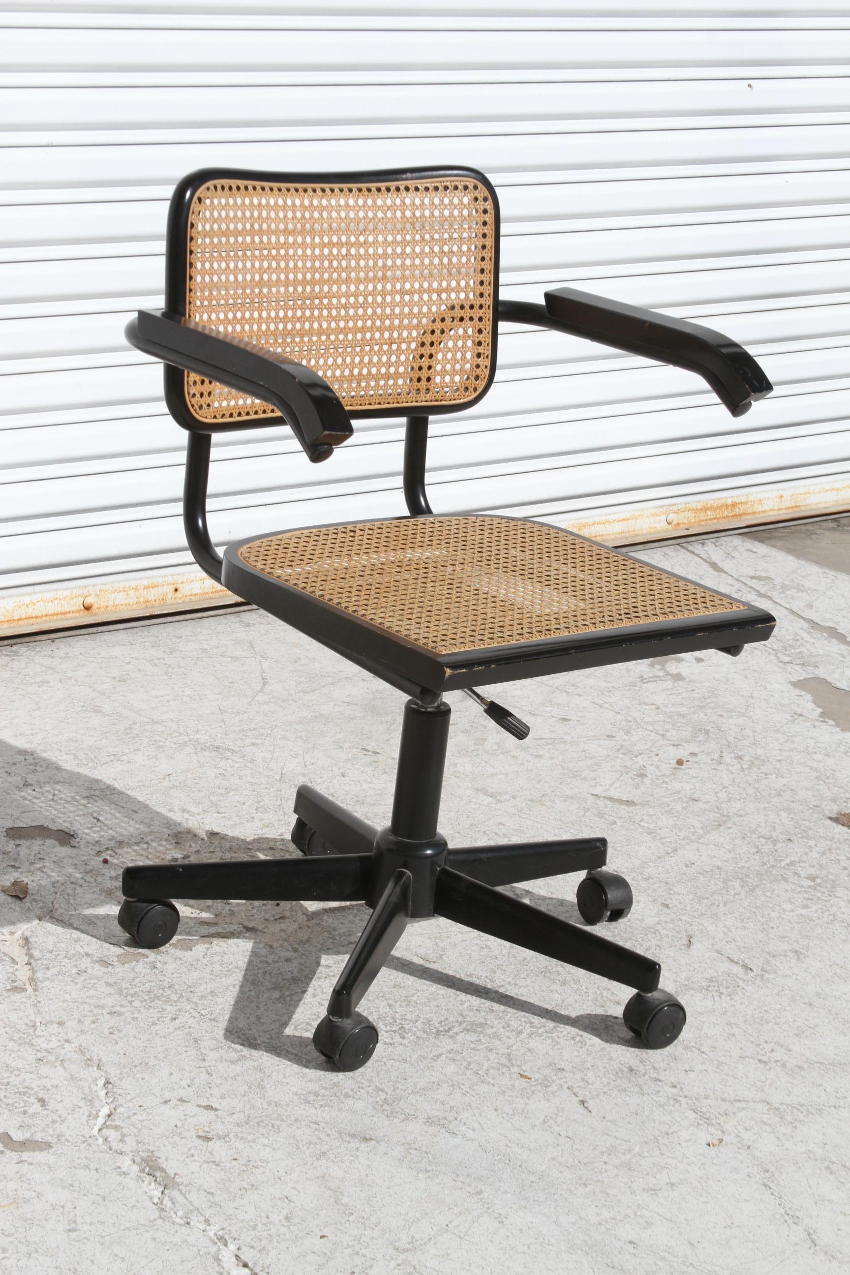 Il s'agit d'une belle chaise longue Thonet. Il est fait de métal, de bois et de canne. Le siège est réglable et pivotant. Le dossier et l'assise sont en rotin. Les bras sont en acier recouvert de bois ébonisé. La chaise a l'aspect d'une chaise Knoll