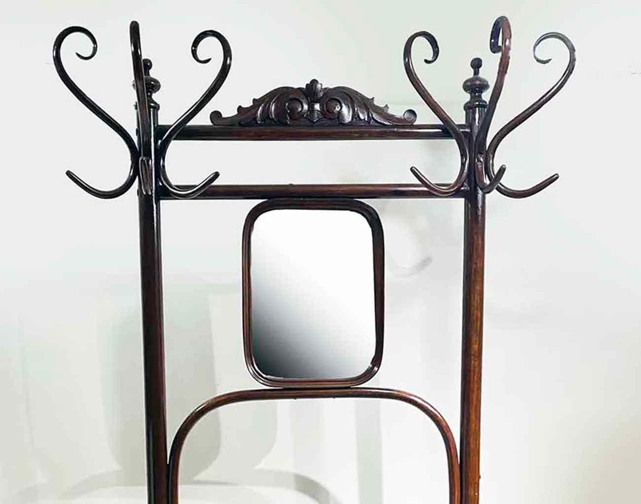 This Classic Thonet style hat and coat rack is made of beautifully finished bentwood. 
Each stand features three top bentwood hooks with a mirror in the middle.
This piece would be a nice decorative addition to an entry, dressing room, mudroom or