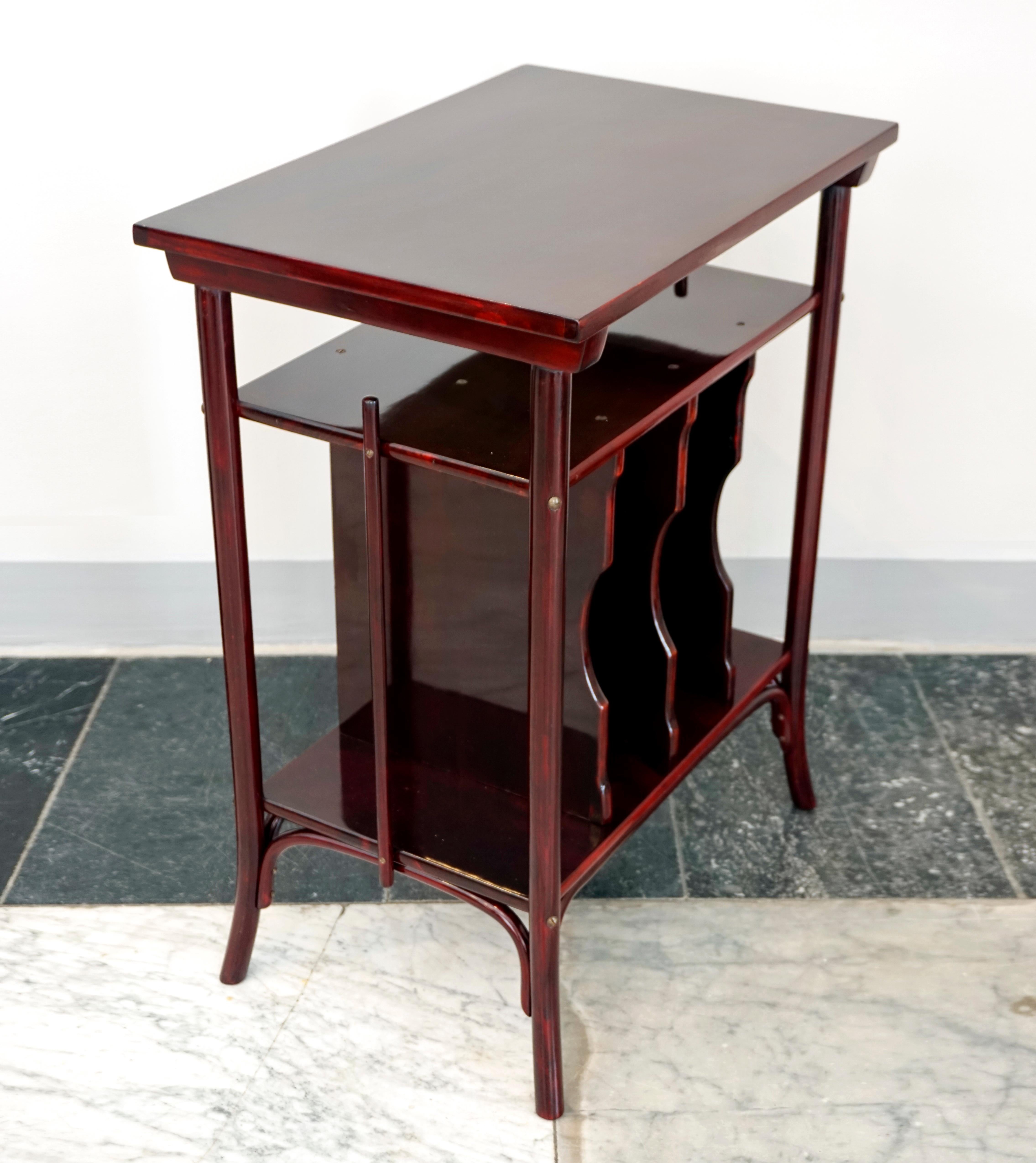 Small table with elegantly curved legs, one horizontal and four vertical slots for notes and newspapers.
Shapely furniture made by hand in high-quality with bentwood elements, beech, stained mahogany, shellac hand-polished. 

Manufactured by THONET
