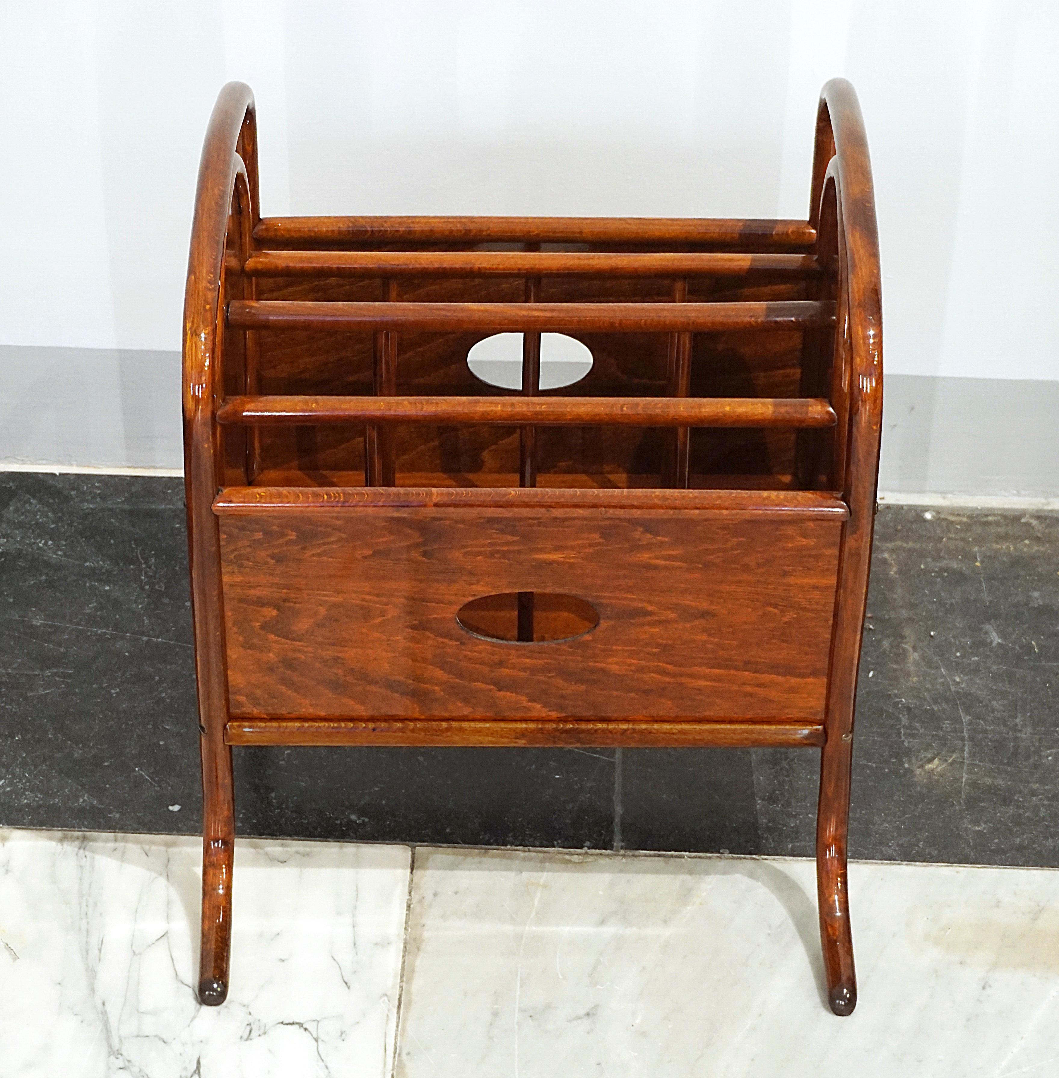 Elegant Art Nouveau magazine holder, or music stand, on outwardly curved feet with inset wooden panels.
High-quality handcrafted furniture with decorative bentwood elements that combine formal beauty and function. Beech, stained light mahogany,