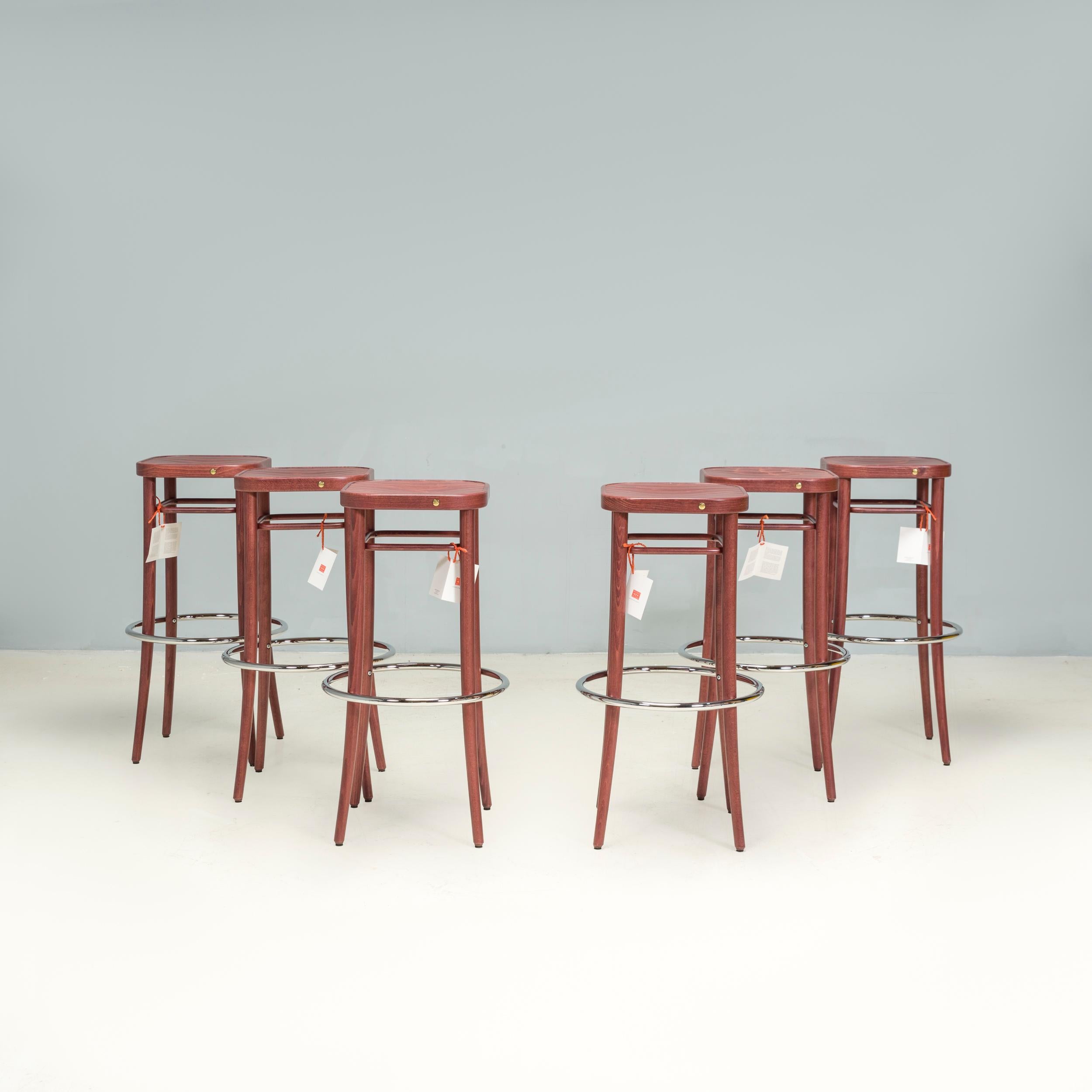 Originally designed in 1908 by August Thonet, the Barhocker stool uses the same techniques as the iconic bentwood chairs from the same era.

Manufactured by Gebrüder Thonet Vienna in 2015, this set of six  stools are constructed from walnut