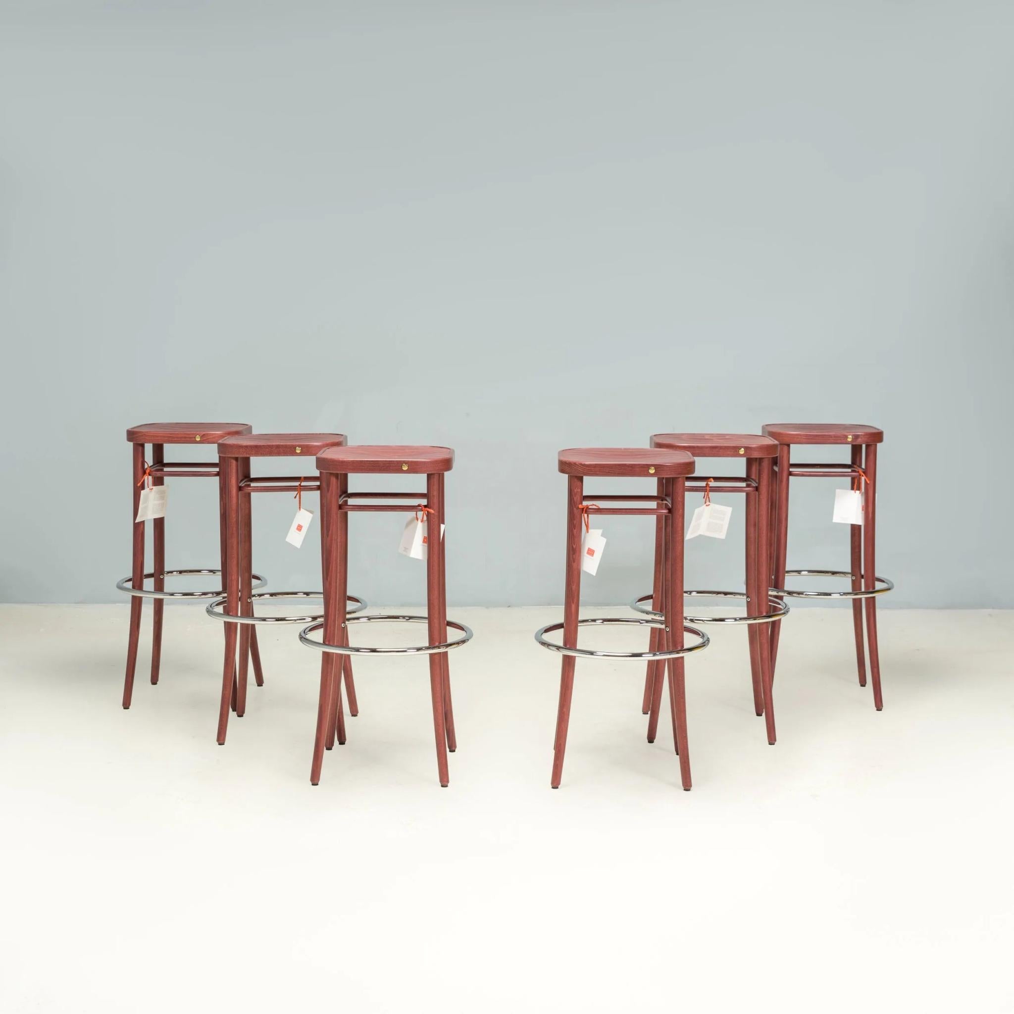 Originally designed in 1908 by August Thonet, the Barhocker stool uses the same techniques as the iconic bentwood chairs from the same era.

Manufactured by Gebrüder Thonet Vienna in 2015, this set of six  stools are constructed from walnut