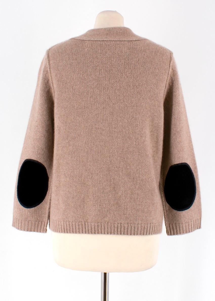 Thor & Nema Cashmere Cardigan

- V-neckline
- Long sleeves
- Elbow patches
- Ribbed trims 
- Three fur snap-buttons to the front
- Two pockets to the front 

Approx
Measurements are taken laying flat, seam to seam. 
Length: 58cm
Waist: 44cm
Sleeve: