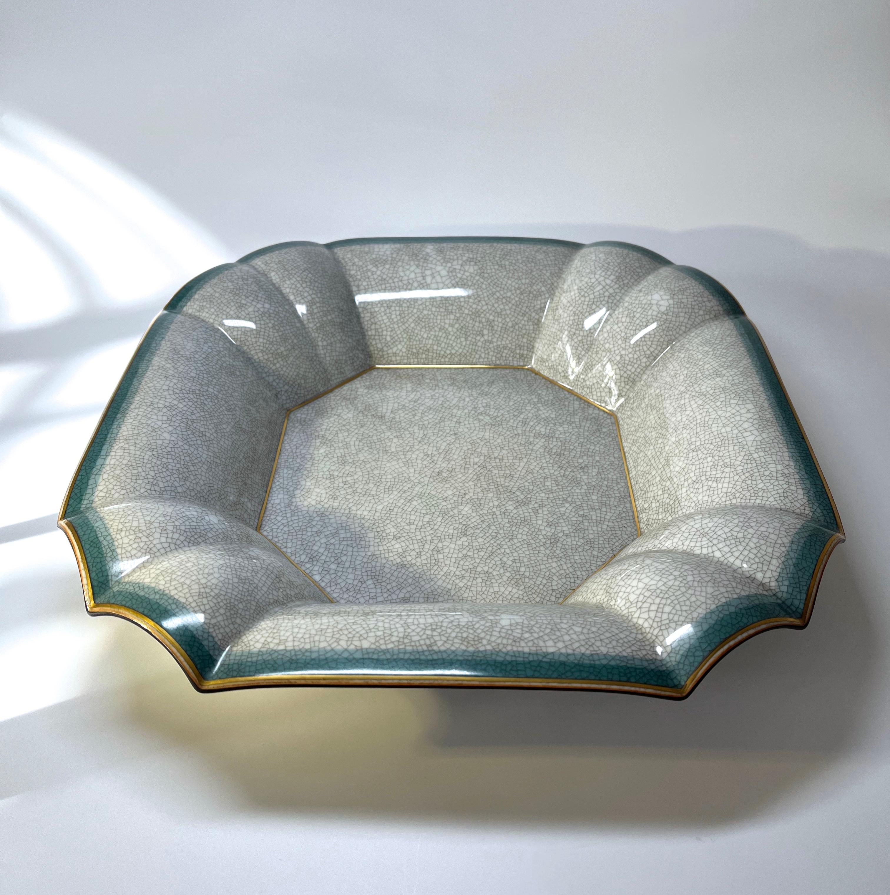 A most unusual dual purpose porcelain piece designed by Thorkild Olsen for Royal Copenhagen
The sizeable piece can be used either as a bowl or wall hanging
Outer rim is banded with gilding and two tones of teal, the centre is a soft grey crackle
