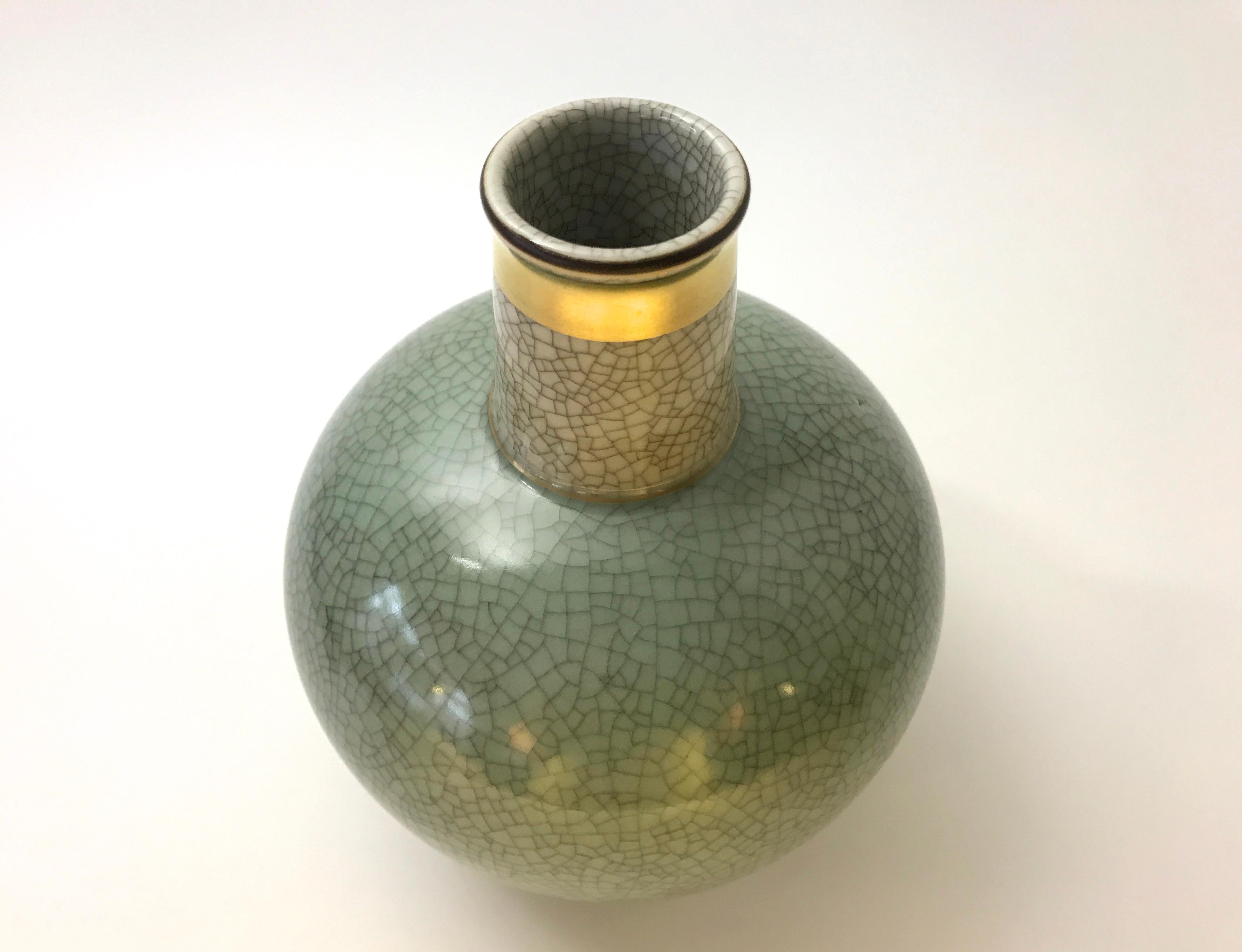 Thorkild Olsen for Royal Copenhagen porcelain pale green crackle glazed vase with gilded banding on neck
Understated elegance from Denmark,
circa 1954
Stamped and numbered 3593
Measures: Height 6.5 inch, diameter 5 inch
Excellent condition.