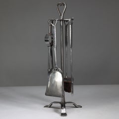 Thornton and Downer. A set of four Cotswold School hand made steel fire tools.