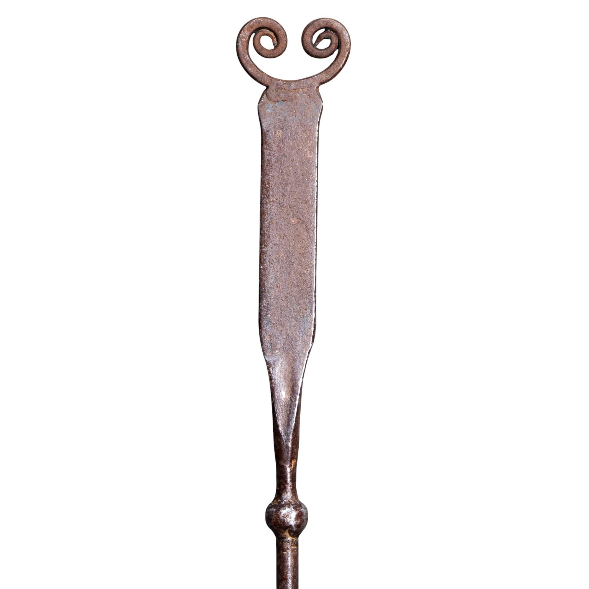 Thorton e Downer, attribuiti.
Un attizzatoio in acciaio lucido battuto a mano della Cotswold School di Arts and Crafts, caratterizzato da un terminale appiattito con due volute, un gambo finemente attorcigliato e un'estremità affusolata e