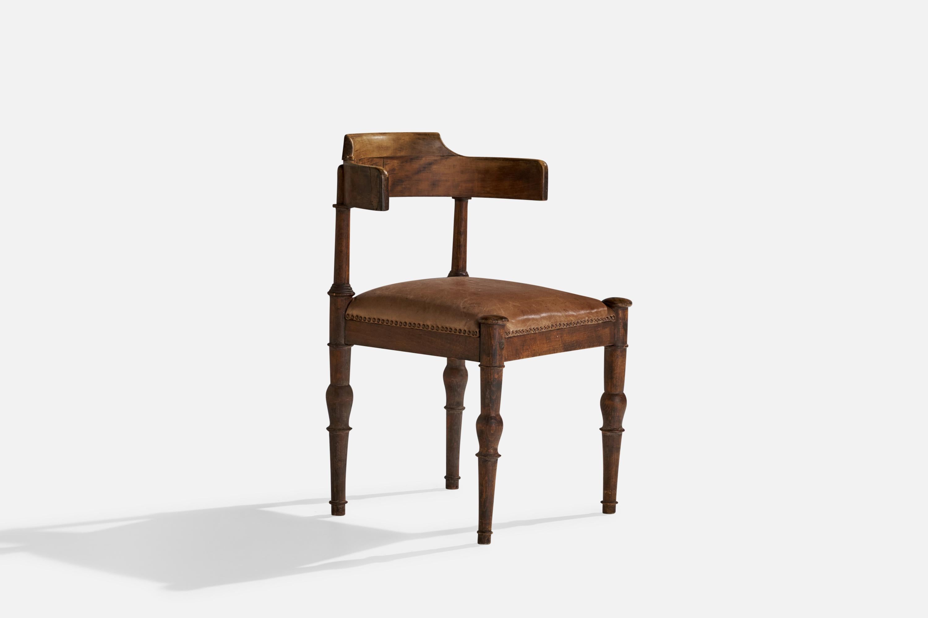 A leather and wood side chair designed and produced by Thorvald Bindesbøll, Denmark, c. 1900.

seat height 19”.