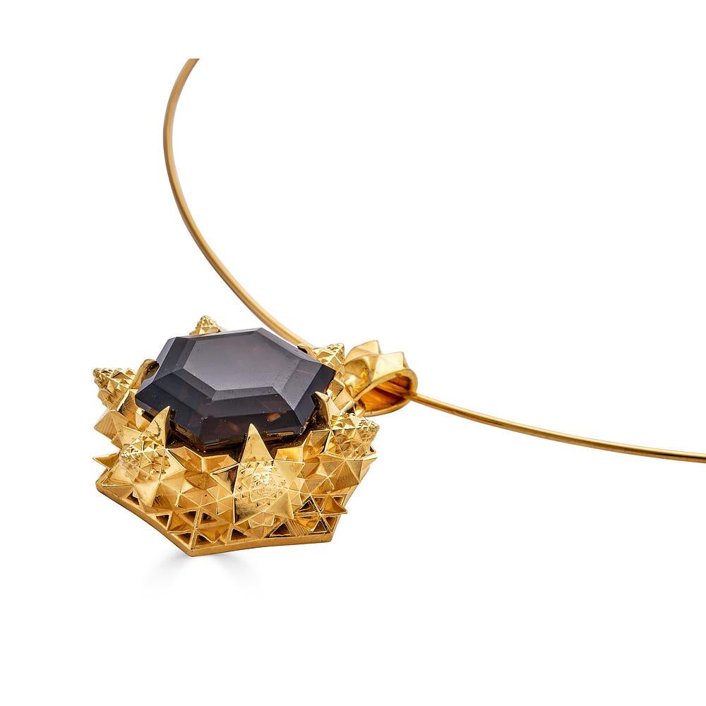 Thoscene collection pendant in gold with a 14mm hexagonal smoky quartz stone set in 18K gold. Smoky quartz is traditionally used to absorb negative energies and to protect from evil. This necklace is meant to empower the wearer. This piece was