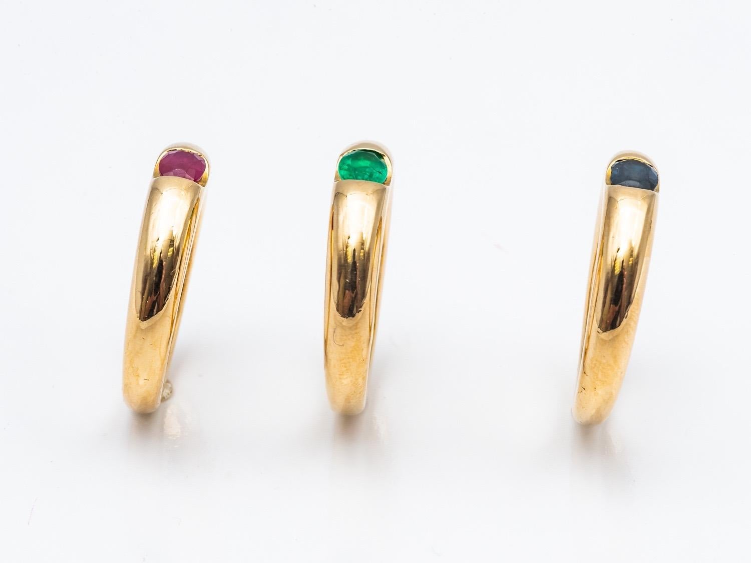Three 18 Karat Gold Bangles Rings Set with an Emerald, a Sapphire, and a Ruby 4