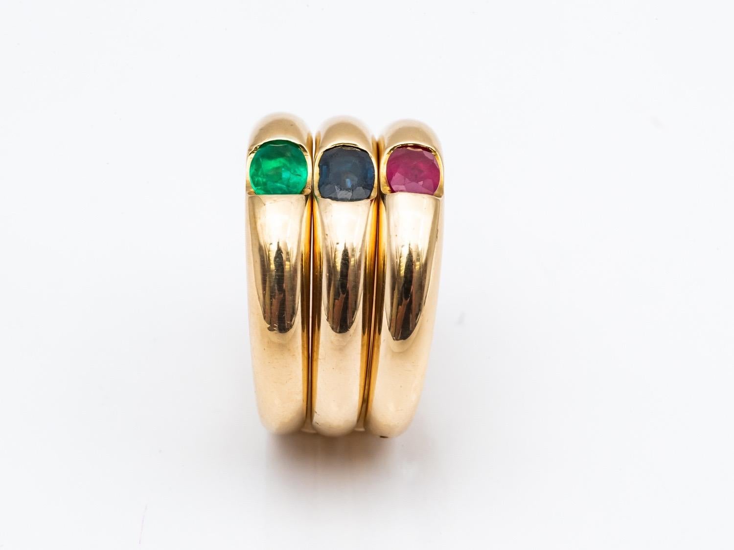 Three 18 Karat Gold Bangles Rings Set with an Emerald, a Sapphire, and a Ruby 10