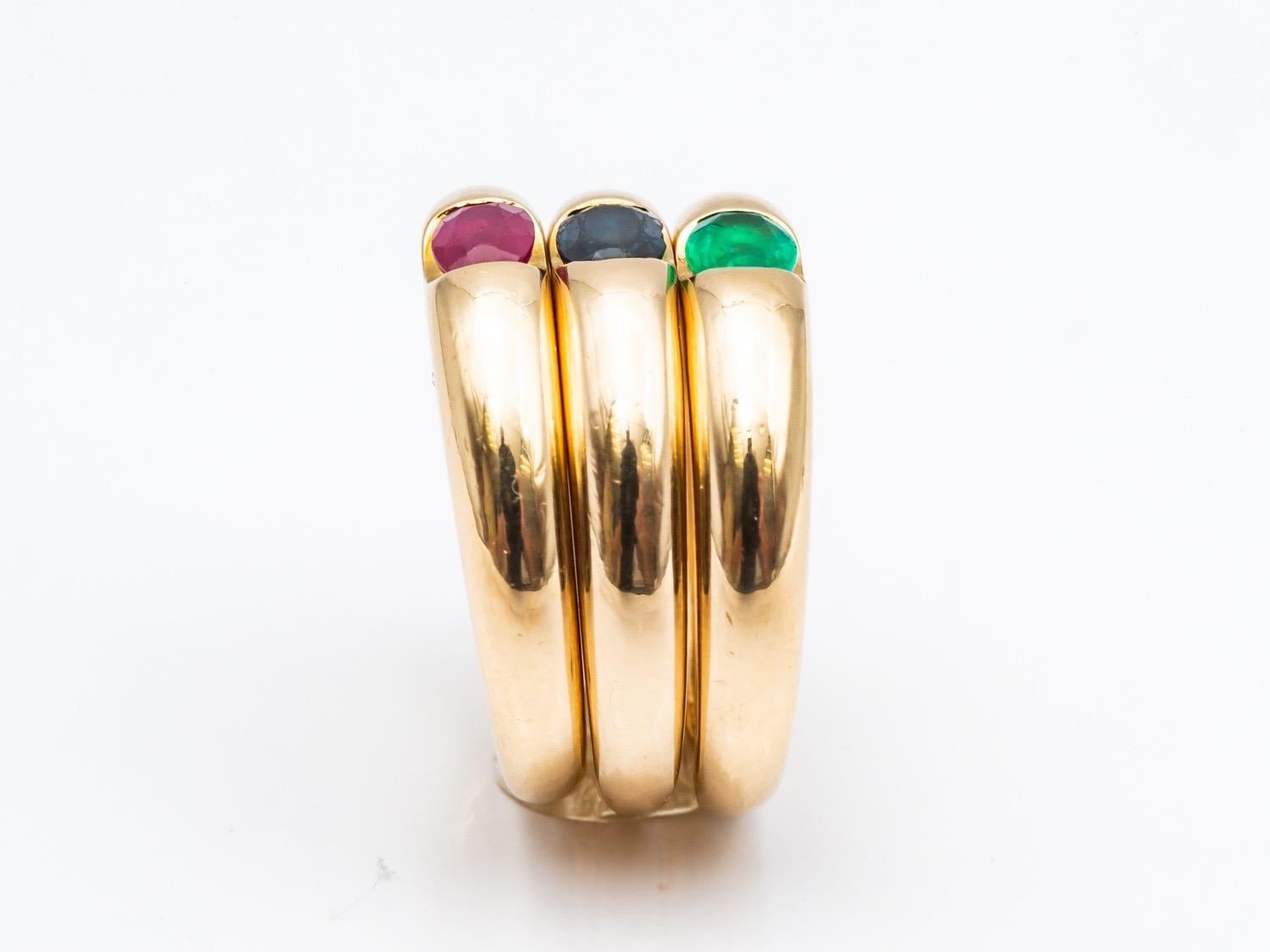 Contemporary Three 18 Karat Gold Bangles Rings Set with an Emerald, a Sapphire, and a Ruby