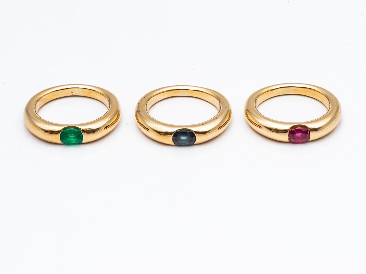 Three 18 Karat Gold Bangles Rings Set with an Emerald, a Sapphire, and a Ruby 3