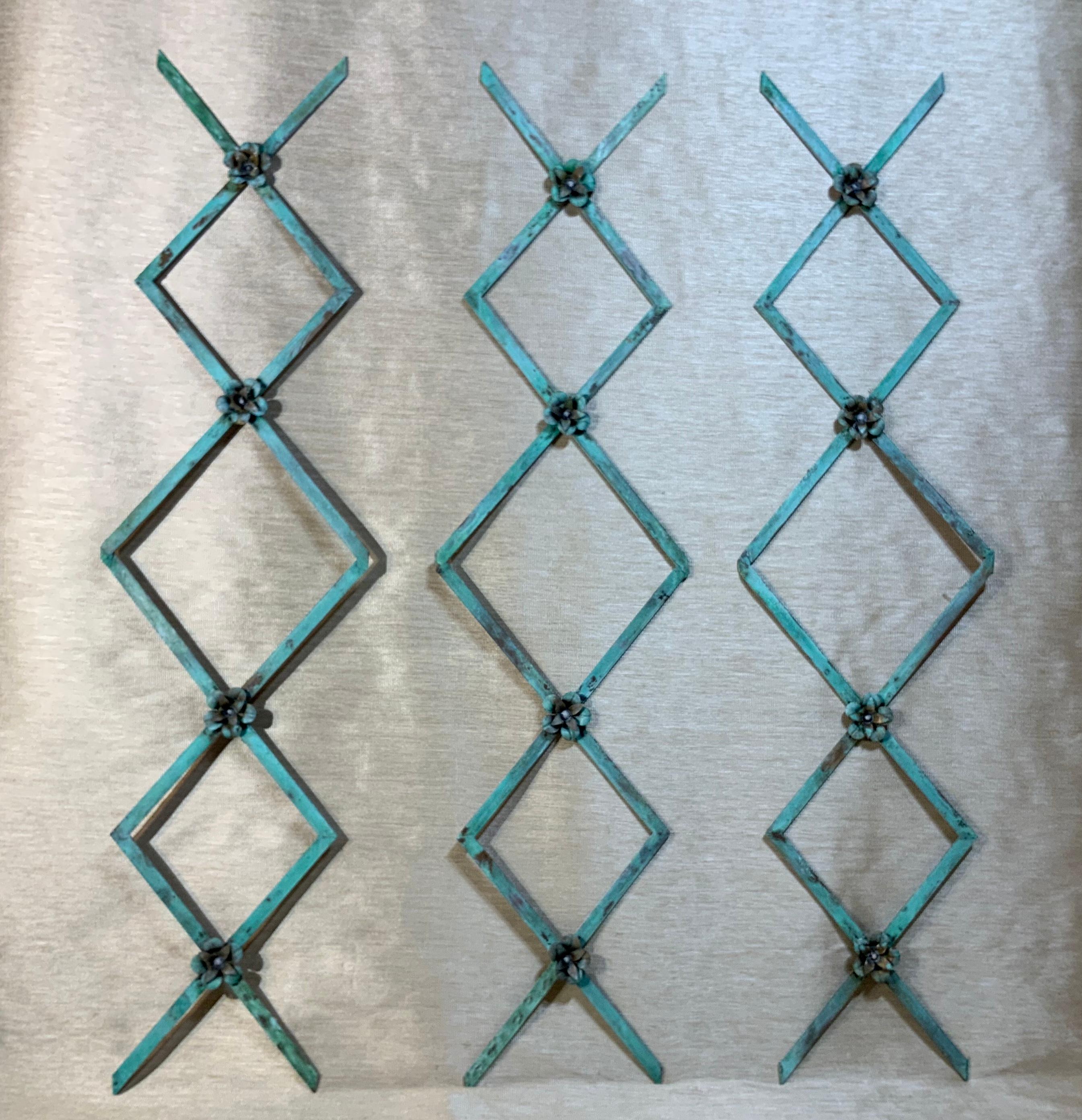 Elegant wall hanging ornaments made of solid brass, originally part of 19th century screen salvage. Exquisite verdigris patina, light, will make exceptional decorative wall hanging, three pieces only.
The size: 34” x 8”.75 x 0.25 each panel.