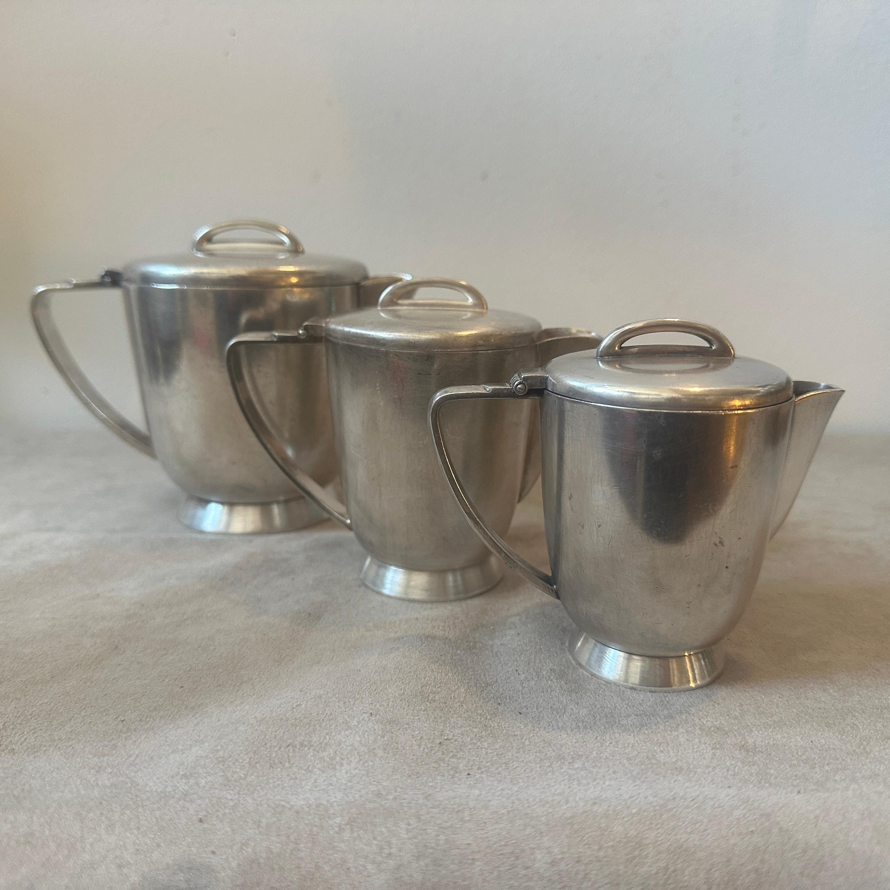 A set of three alpaca coffee pot designed by Gio Ponti and manufactured by Fratelli Calderoni in the Fifties, they were used in the hotels and they are marked on the bottom Calderoni, they are in original conditions with normal signs of use and age.