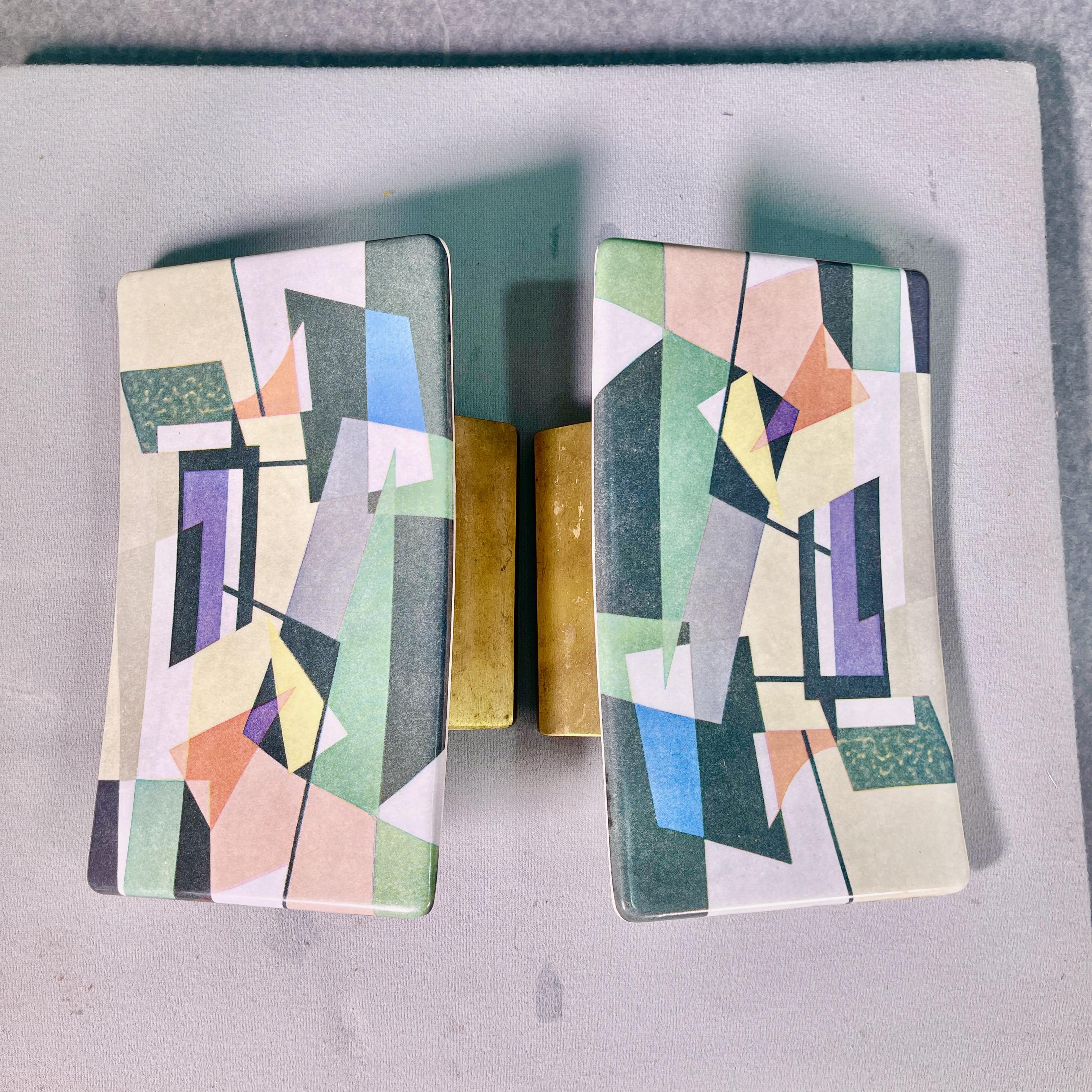We have three of these chic mid-century Italian door pulls made of melamine with cast brass hardware with an abstract expressionist design lithograph transferred onto the plate.
Priced individually.