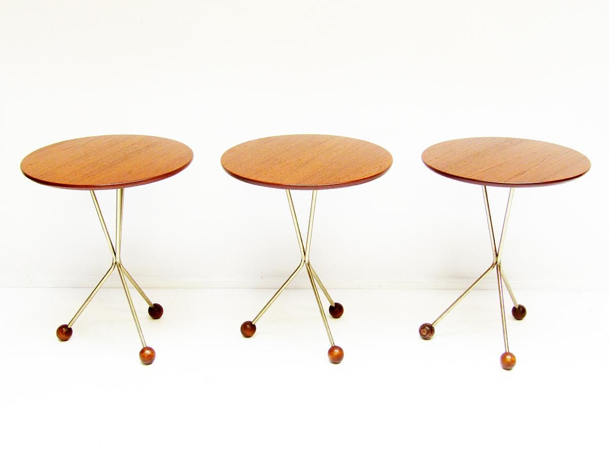 A trio of circular 1950s side tables in teak by Albert Larsson for Alberts Tibro.

Perfect examples of Swedish design, they have atomic brass legs with wooden globe feet.

Carefully restored, they are in excellent structural and aesthetic