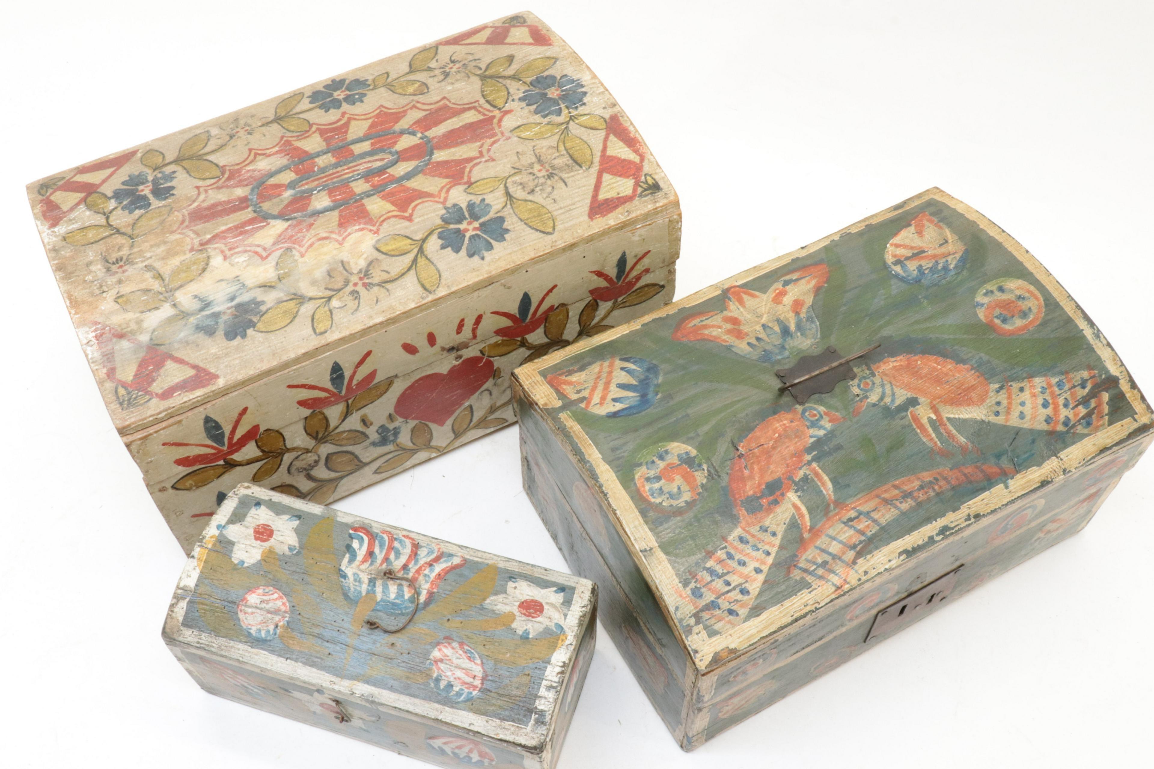 Three early 19th century French Folk Art painted dome-top wedding boxes in beech, decorated with painted flowers, swags, hearts and other motifs. These were traditional filled with linens and other soft goods and given to a bride on her wedding
