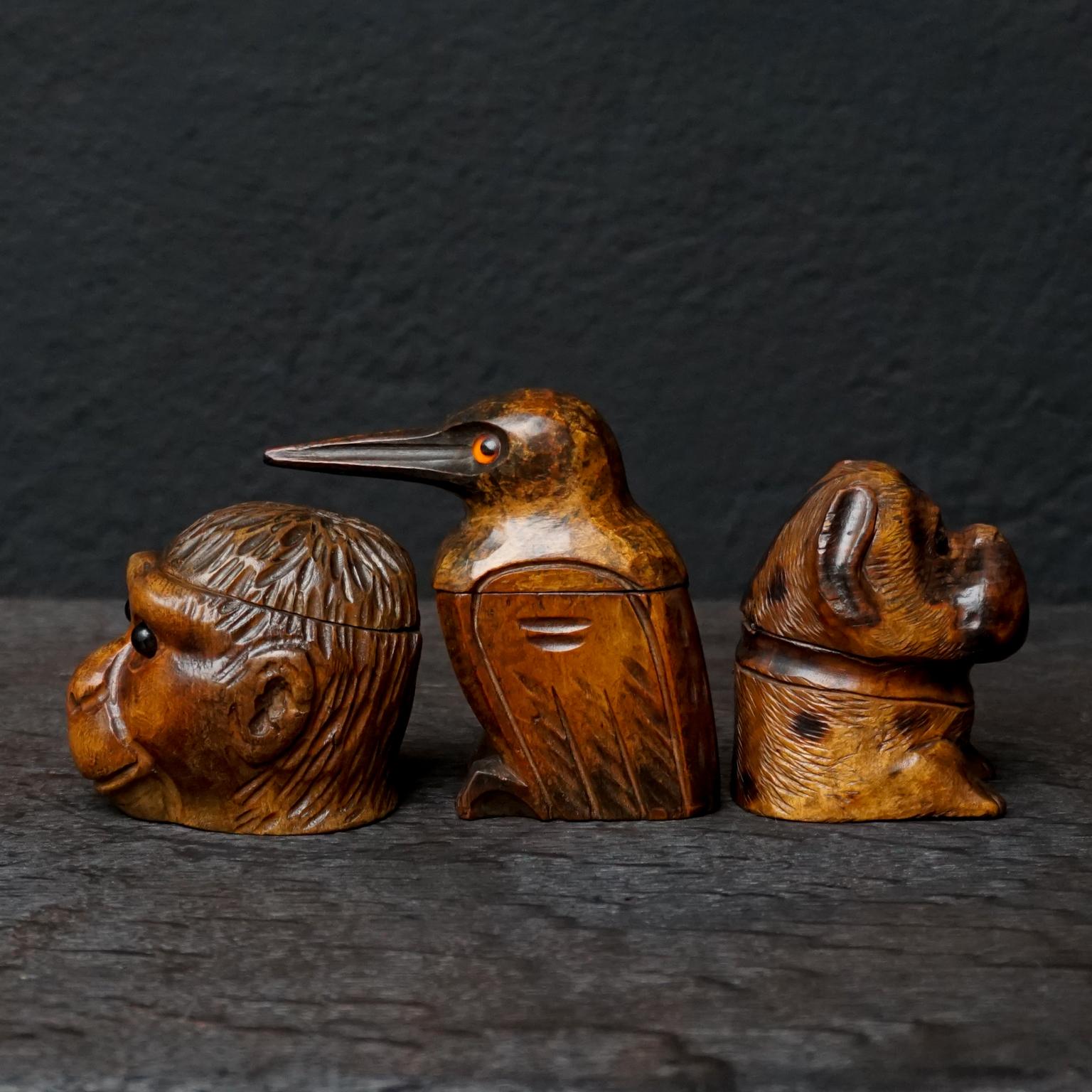 Set of three antique Black Forest hand carved walnut wood hinged ink wells with glass insert eyes.
Made during the mid-late 1800s, in the Brienz area of Switzerland.

I have seen a lot of Black Forest or Schwarzwald carved dogs and bears, but a