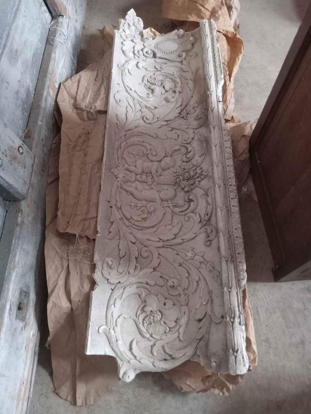 Came out of a building in Waco Texas. 
3 four foot bas relief rococo crown molding pieces. 
Interlocking. 
More thelan 100 years old.
Intricately detailed.
You can still see the faces and bodies of the cherubs clearly. 
Beautiful scrollwork.